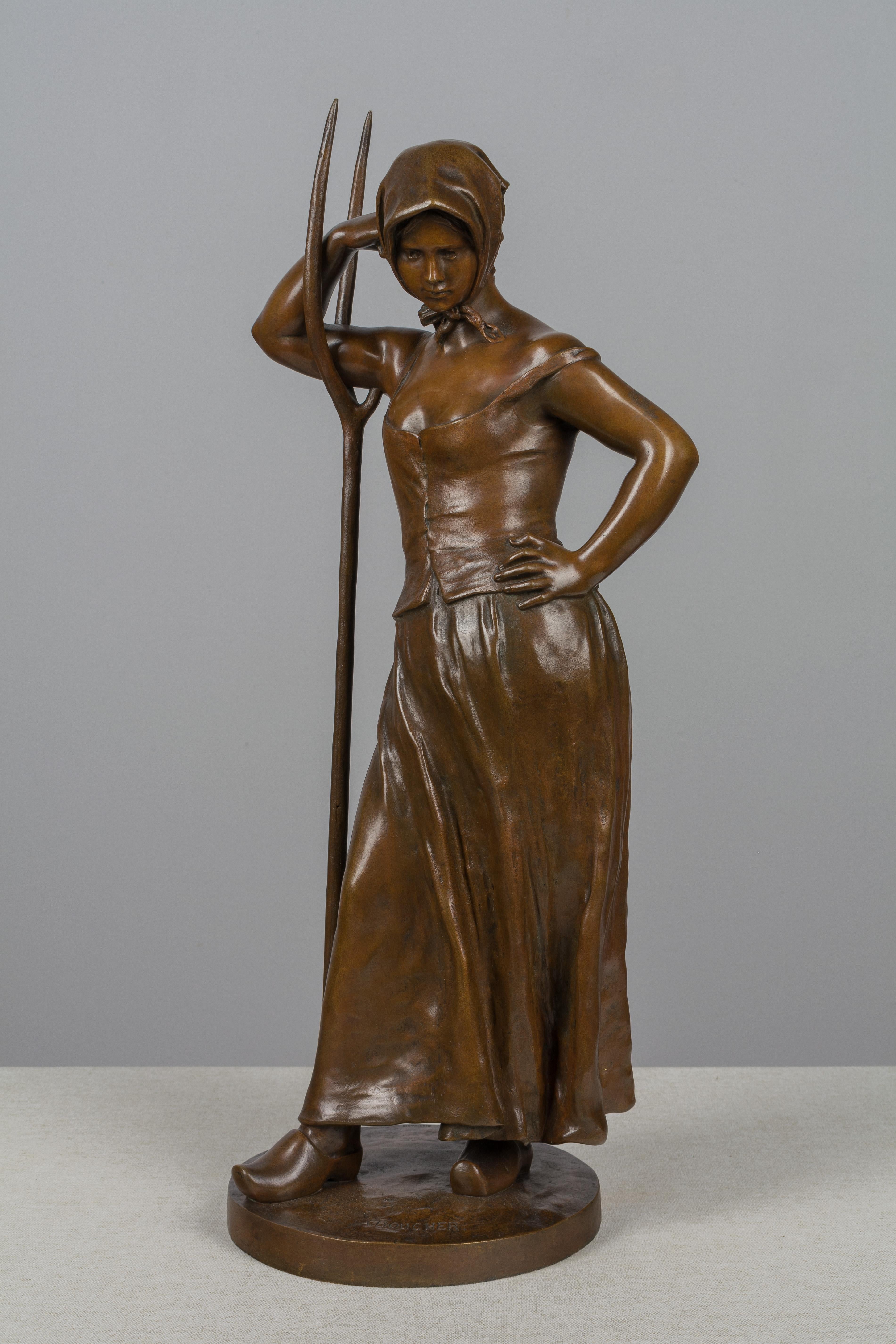 An Art Nouveau patinated bronze sculpture titled 