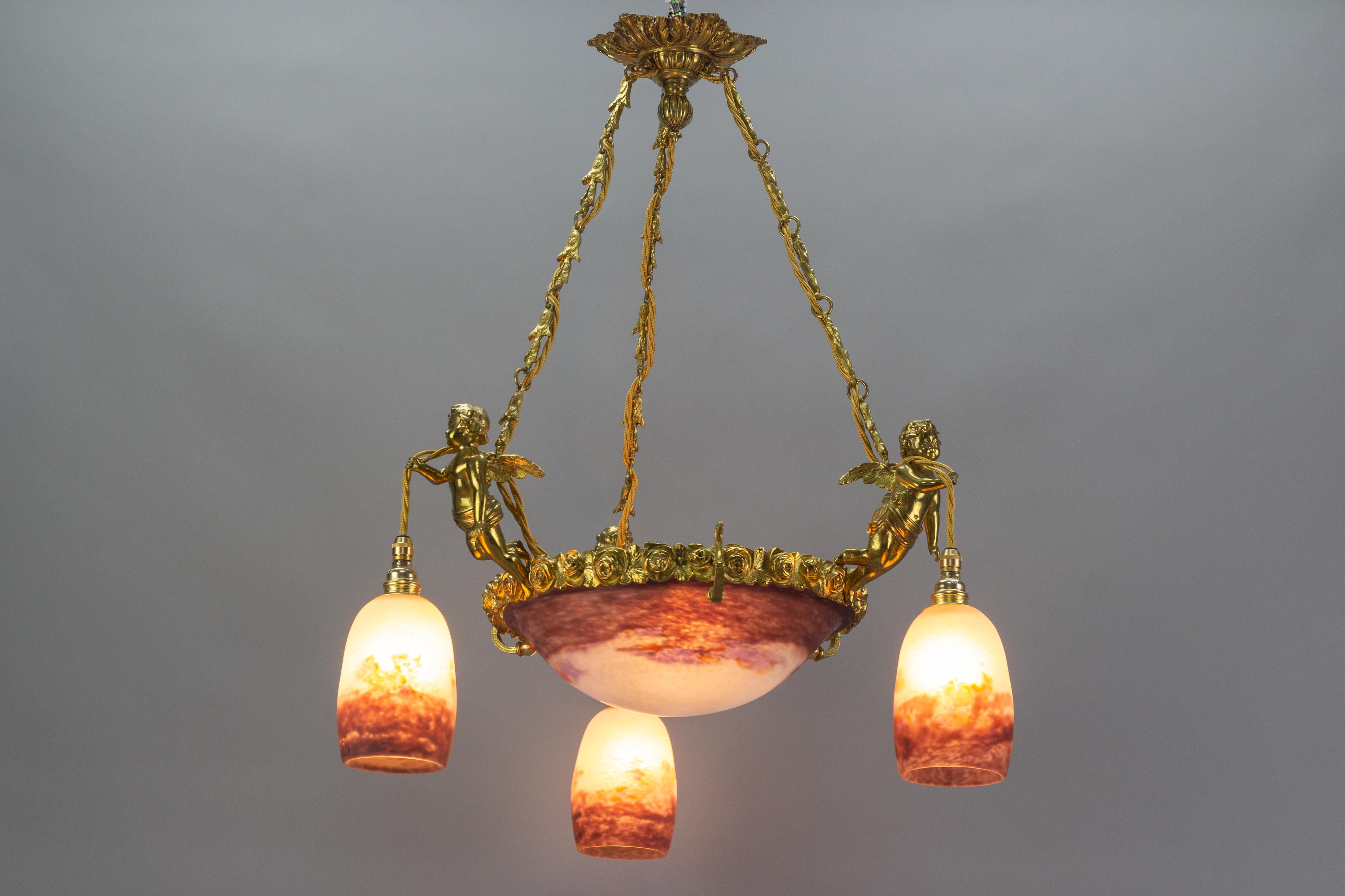 Early 20th Century French Bronze Cherub Chandelier with Violet and White Glass Signed by Degué