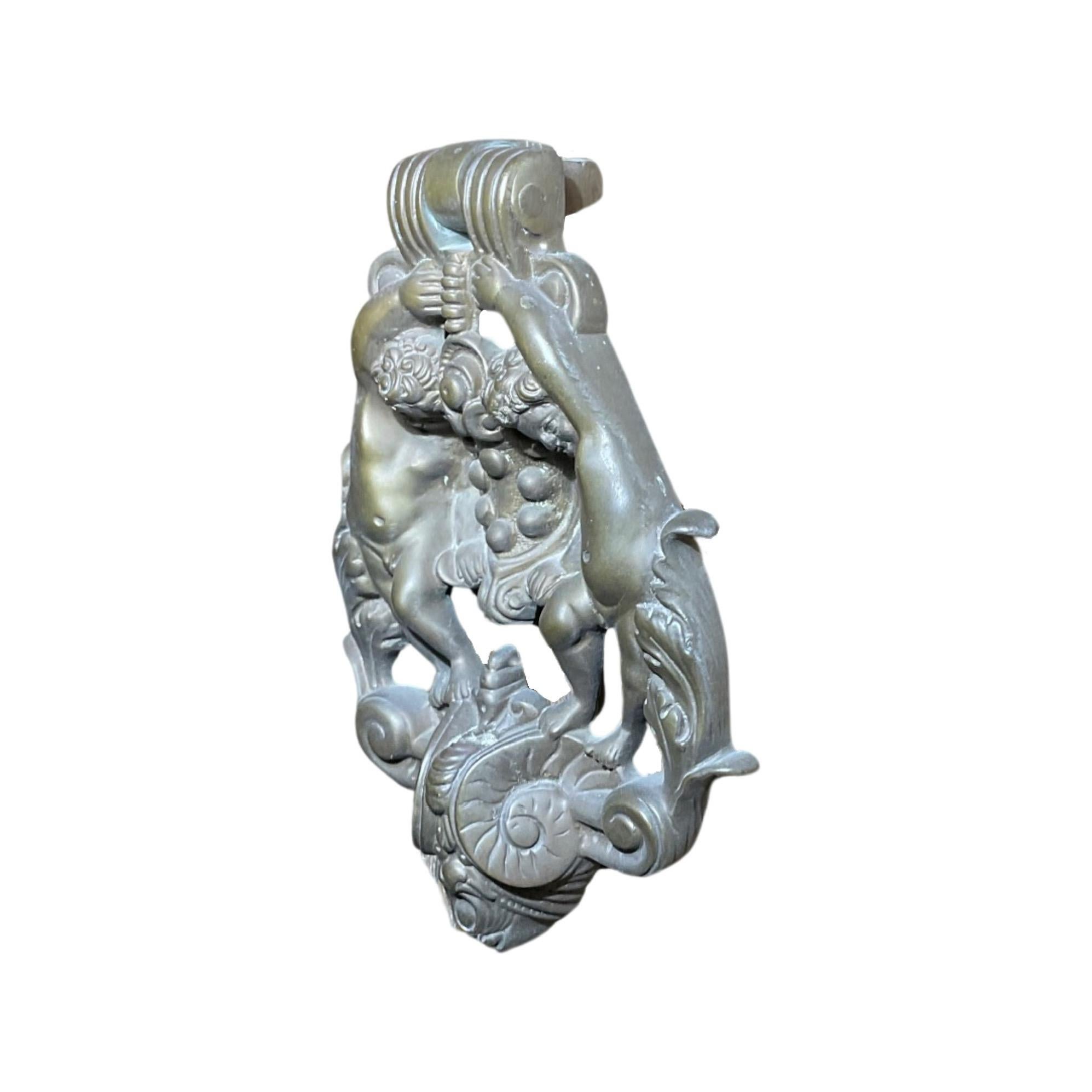 Elevate your door's elegance with our 18th-century French Bronze Cherub Door Knocker. Crafted in France, this bronze door knocker boasts intricately carved cherubs, adding a touch of sophistication to your home's entrance. Enhance your curb appeal