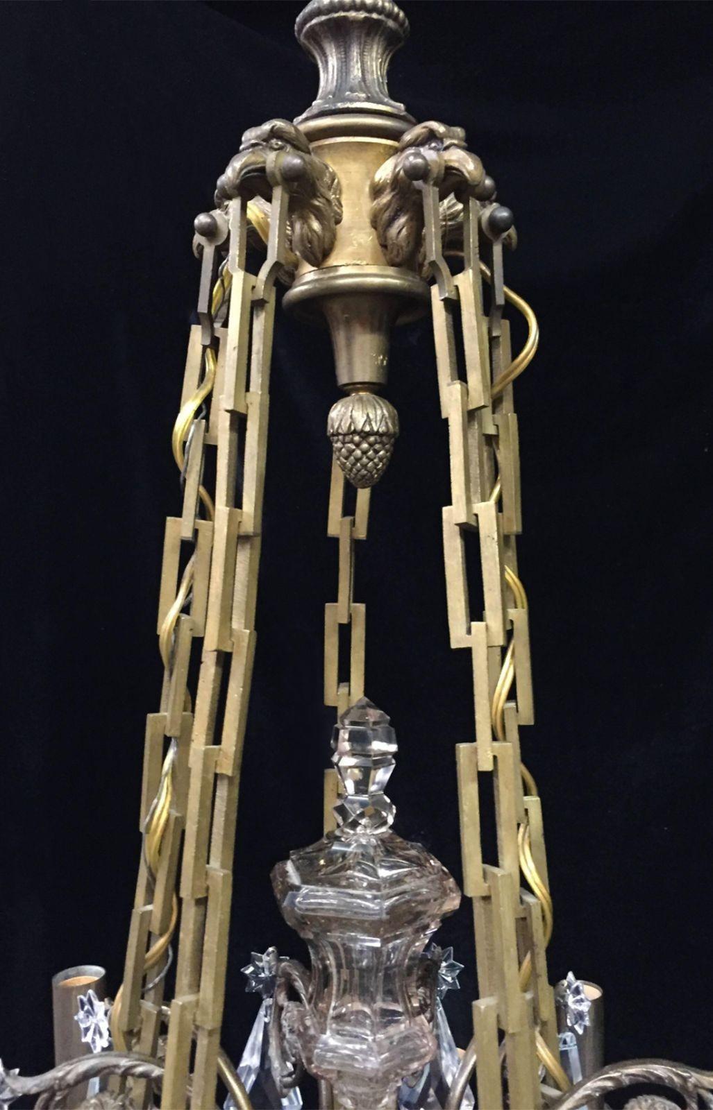 An elegant D'ore bronze and fine crystal chandelier by Baccarat; consisting of 15 lights and a top crown with five gilt bronze eagle heads holding five rectangular form chains bearing the entire piece. Made in France, Late 19th Century/Early 20th