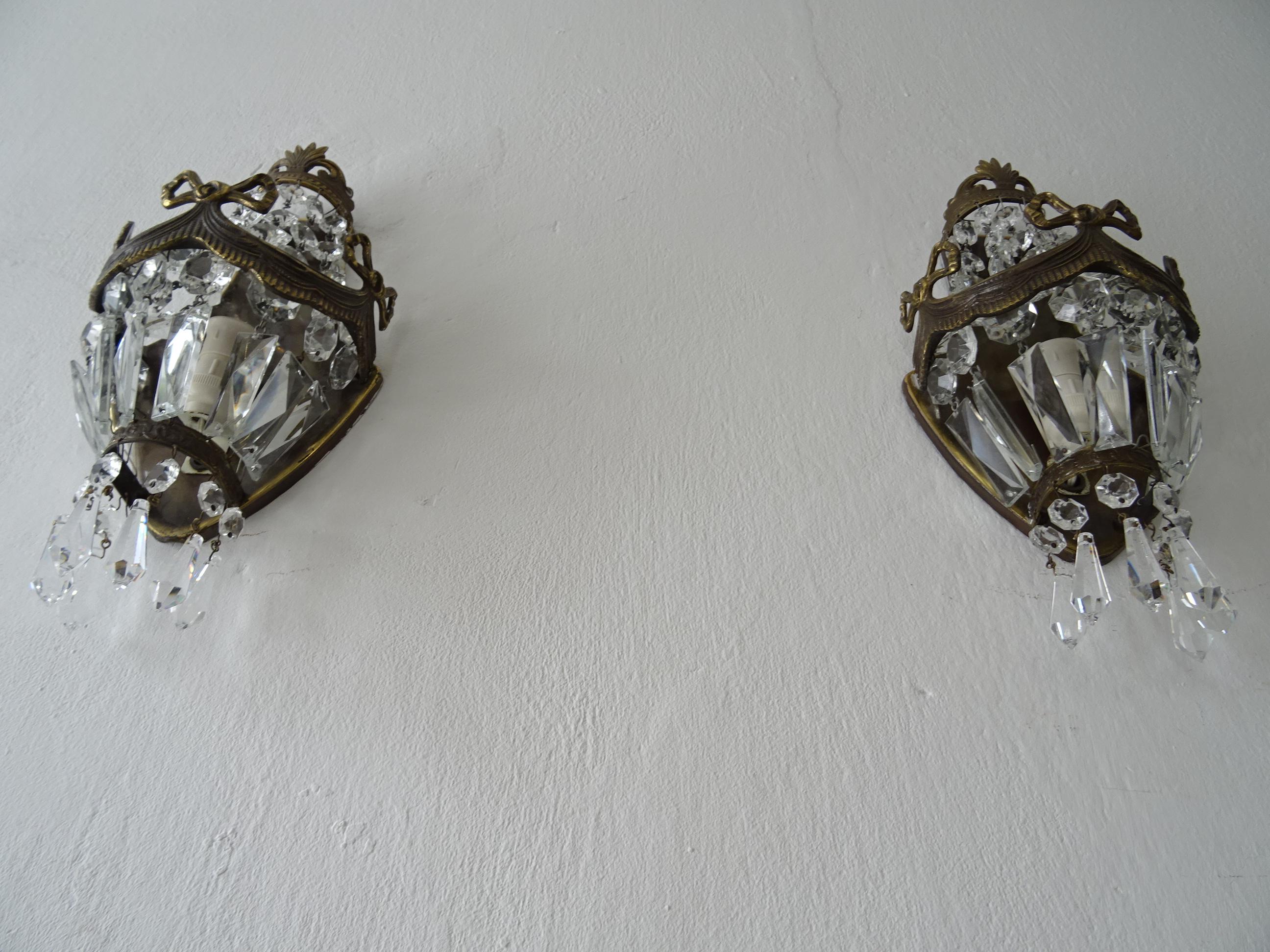 Housing one light each. Will be rewired with certified US UL sockets for the United States and appropriate sockets for all other countries and ready to hang. Bronze detail bows with great patina. Adorning crystal prisms, all intact. Free priority