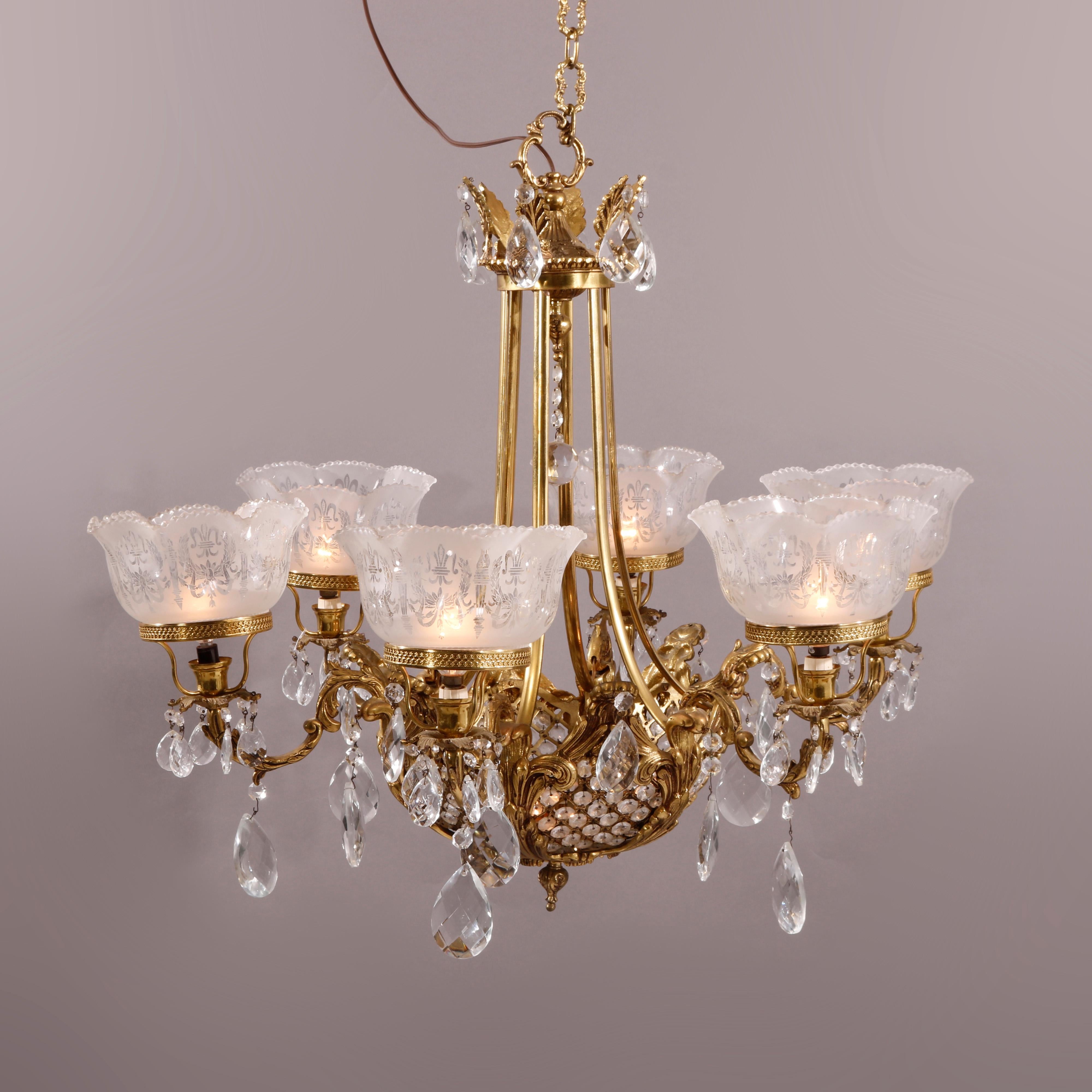 A French style chandelier offers bronze frame with central basket weave bowl having five scroll form arms terminating in candle lights with etched frosted glass shades, cast foliate elements and cut crystals throughout, 20th century

Measures -
