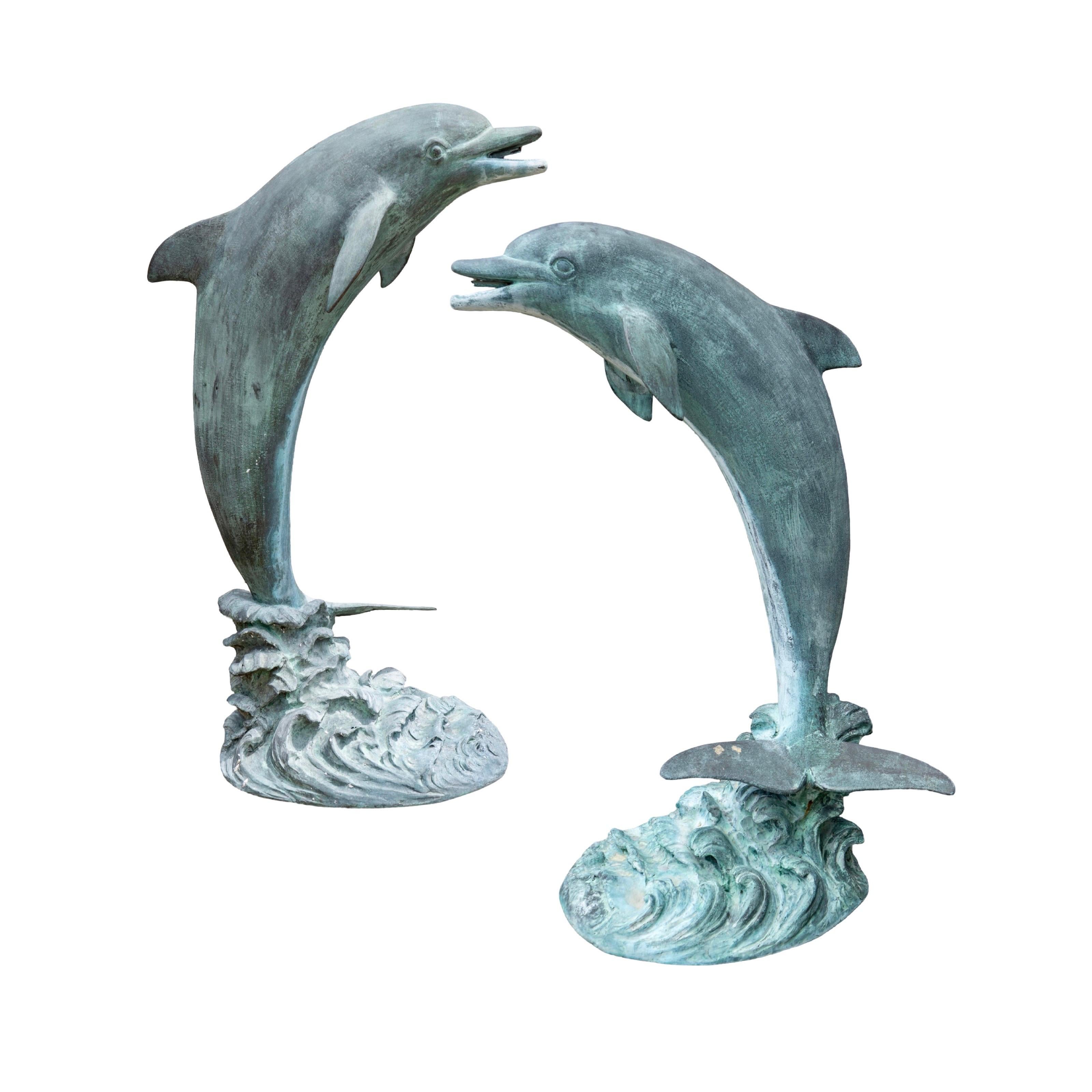 These French Bronze Dolphin Fountains are stunning sculptures from the 1990s. Made in France, each sculpture features an open-mouthed spout for water exiting to make an elegant fountain. Crafted with bronze and an antique finish, these fountains are