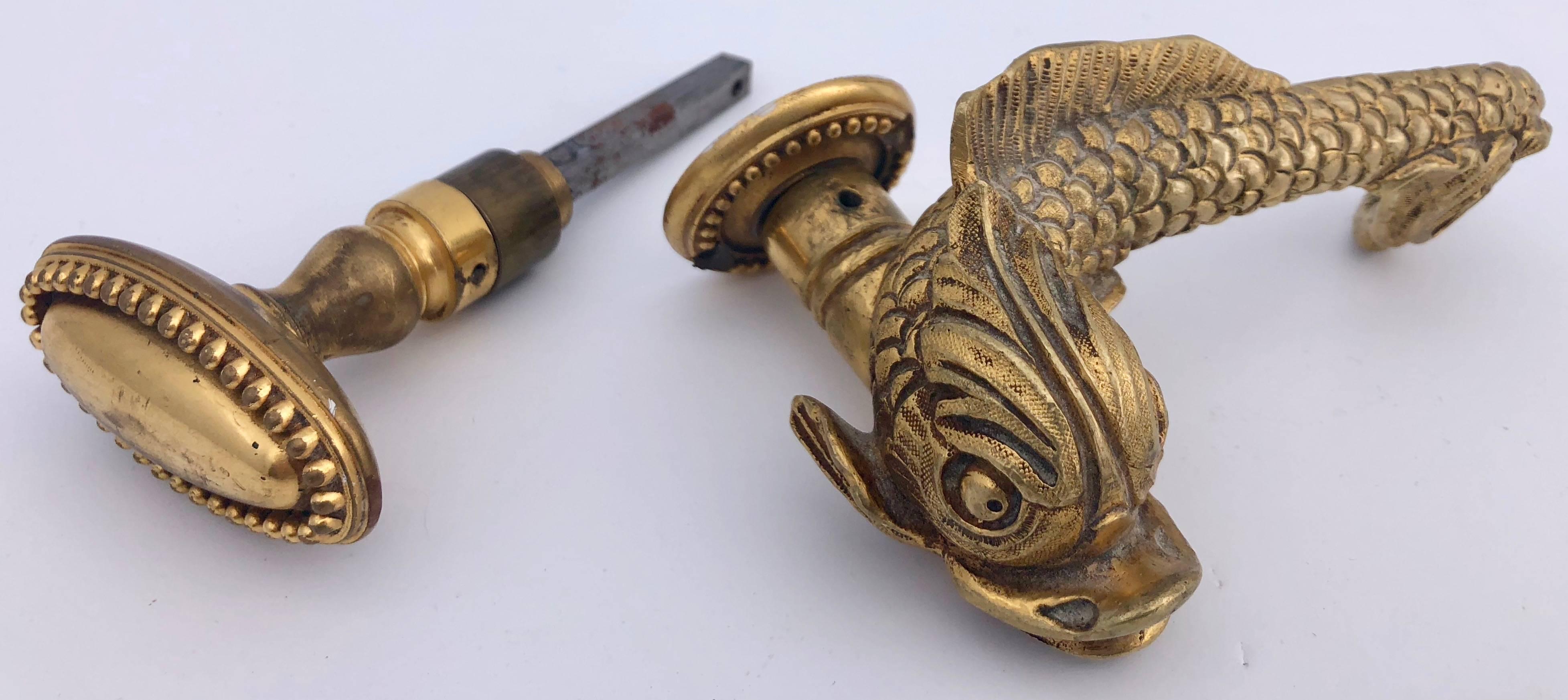 This great French 1950s bronze door handle and knob set are of a beautifully detailed dolphin, and an oval knob, both in the Napoleon III style. They come with their original bronze outer rings and square spindle. The dolphin figure is wonderful