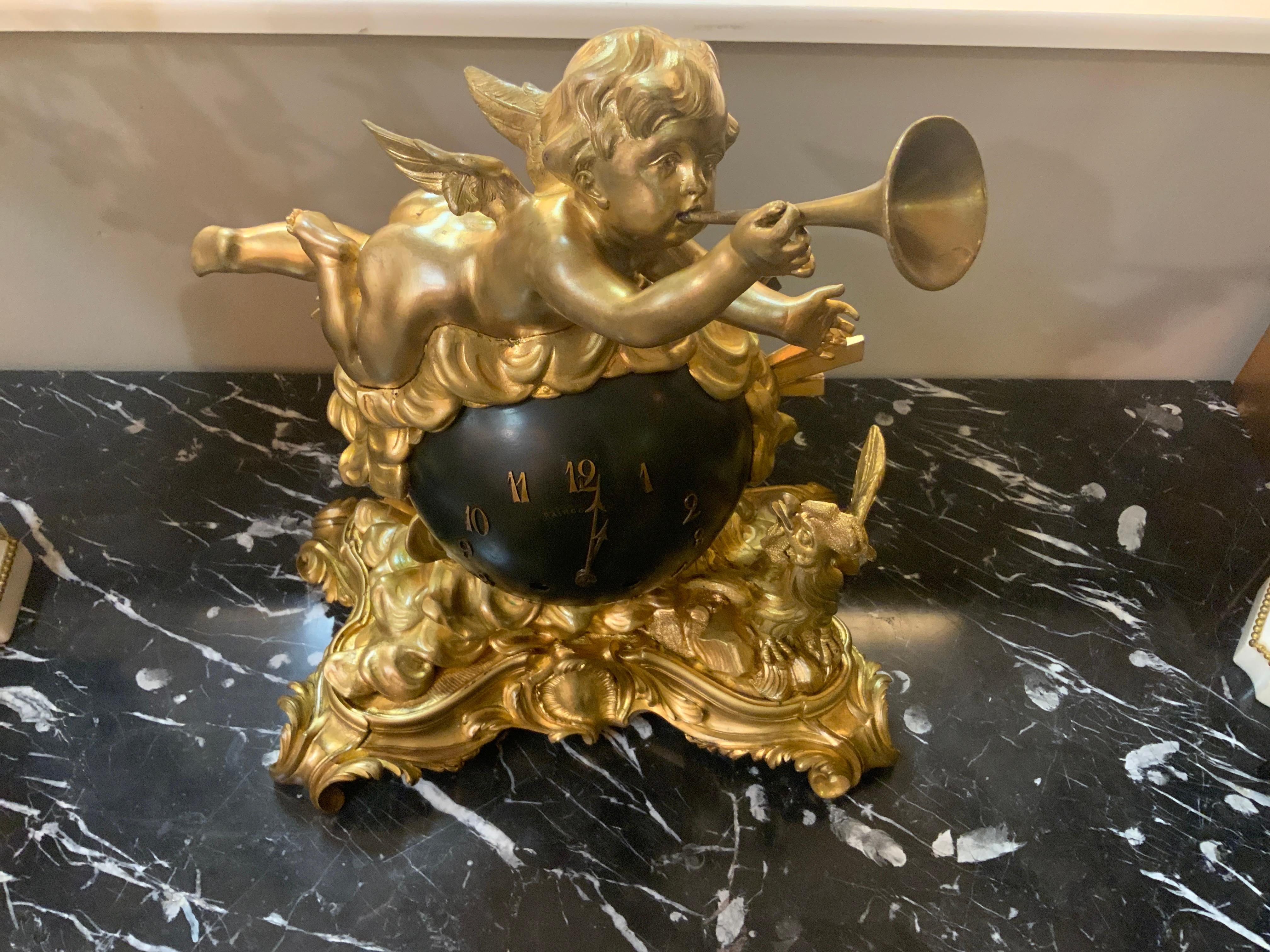 This clock was made by Raingo Feres in Paris
Circa 1890. It is in working condition and come with
The original key and pendulum. It tells a story about 
The emerging day with the angel heralding in the day
With a horn. The rooster is also crowing