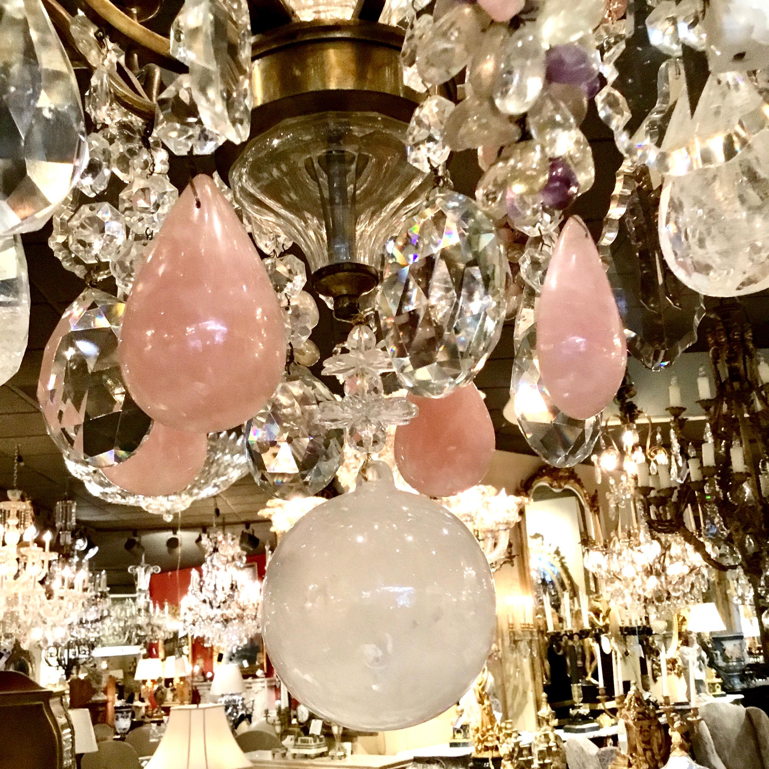Large and spectacular Baccarat style chandelier with multicolored
Crystals and grape-like clusters in amethyst and rock crystals.
Twelve lights are around the perimeter of this piece and one light
Is centered inside a crystal finial. Four large