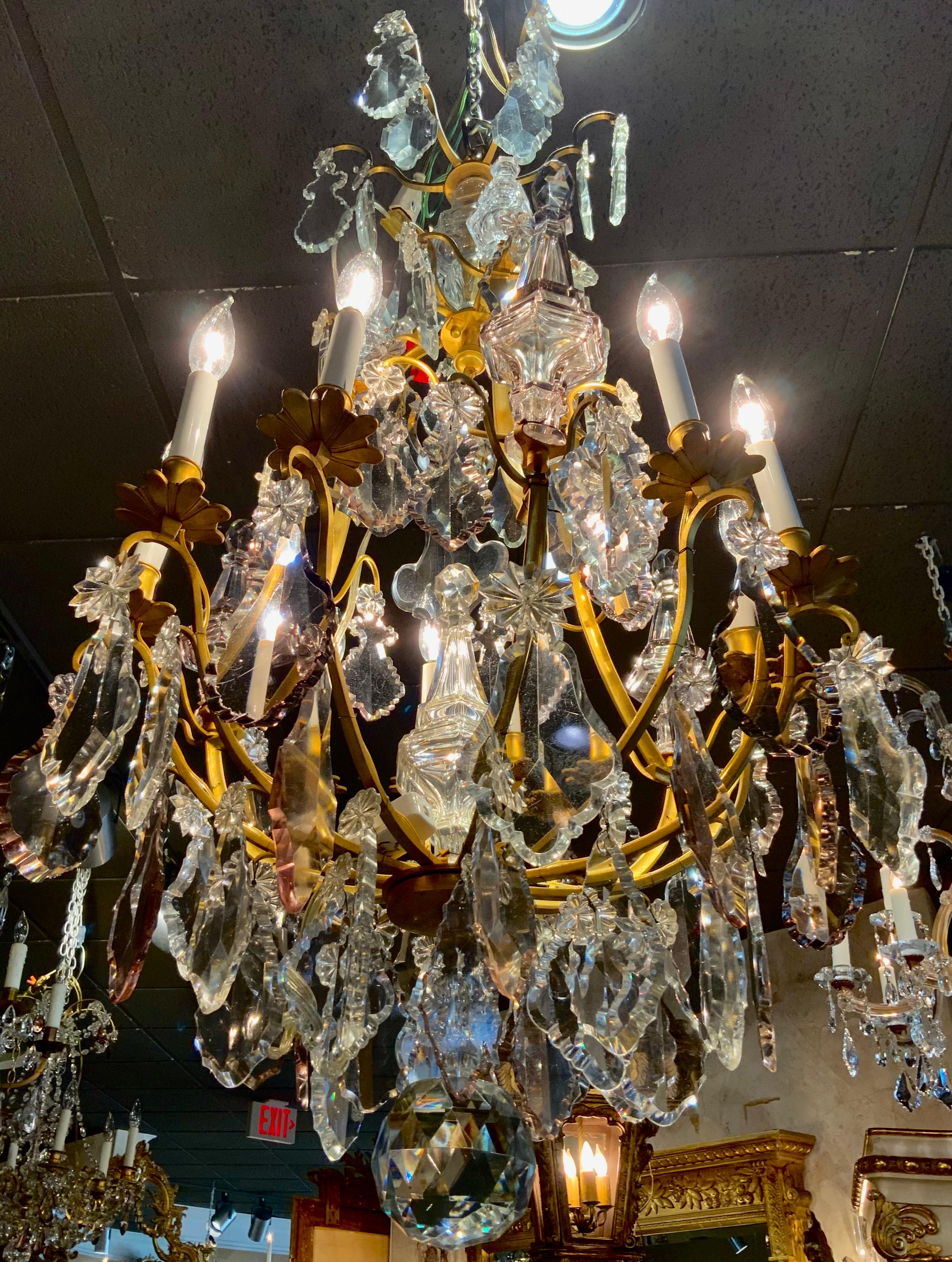 Exceptional French chandelier having nine lights on bronze dore cage.
Crystal that is very clear intermingled with pale lavender crystal
Three large spires around the circumference alternating with the
The lights add special design elements. A