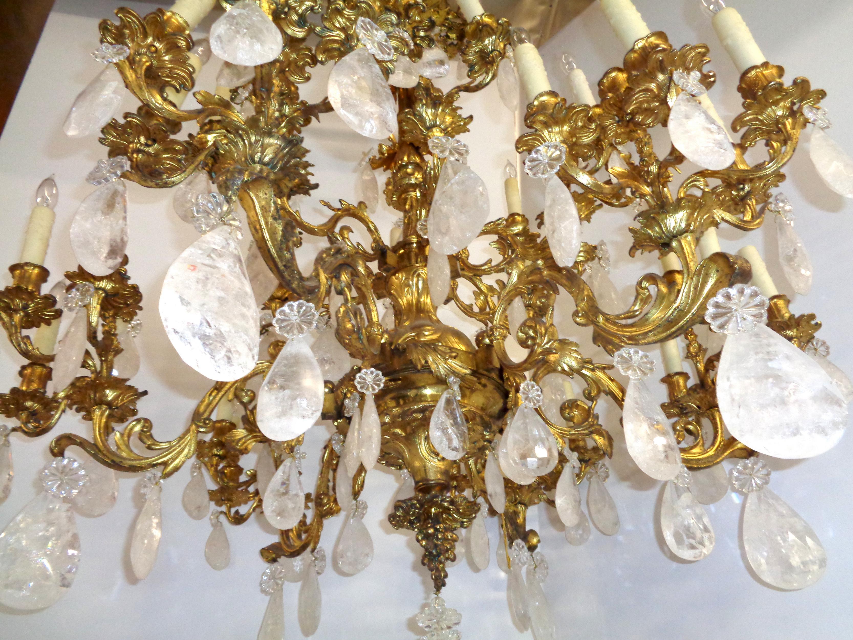 Palatial French Louis XV style bronze doré chandelier with multi-shaped and faceted Baccarat and rock crystals. This magnificent chandelier is beautifully made and has the highest quality craftsmanship. It has six crystal poniards and thirty-tiered