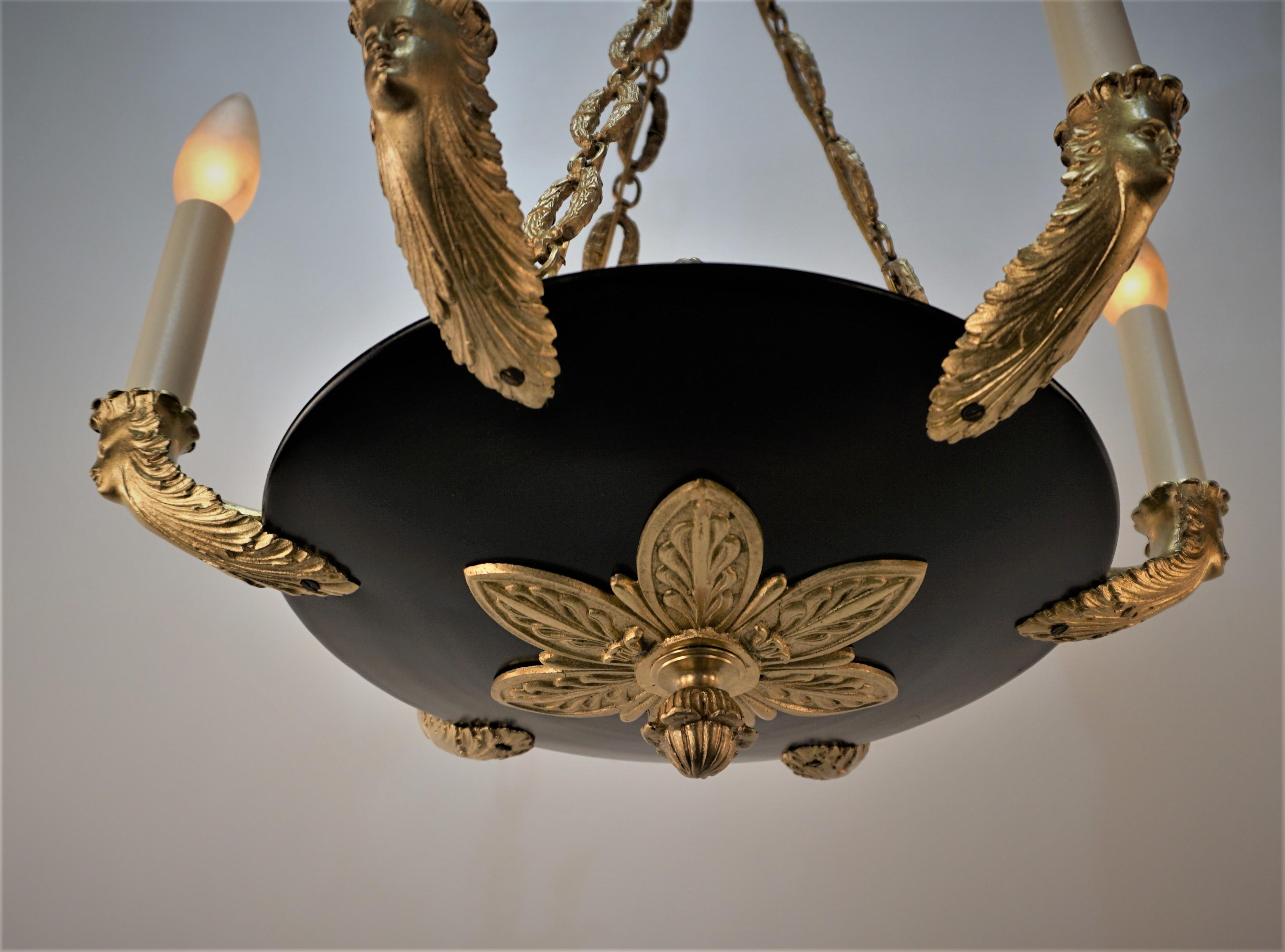 Elegant French empire style bronze chandelier, in golden bronze and black lacquered. New wiring ready for installation, six arms 60 watts max each.