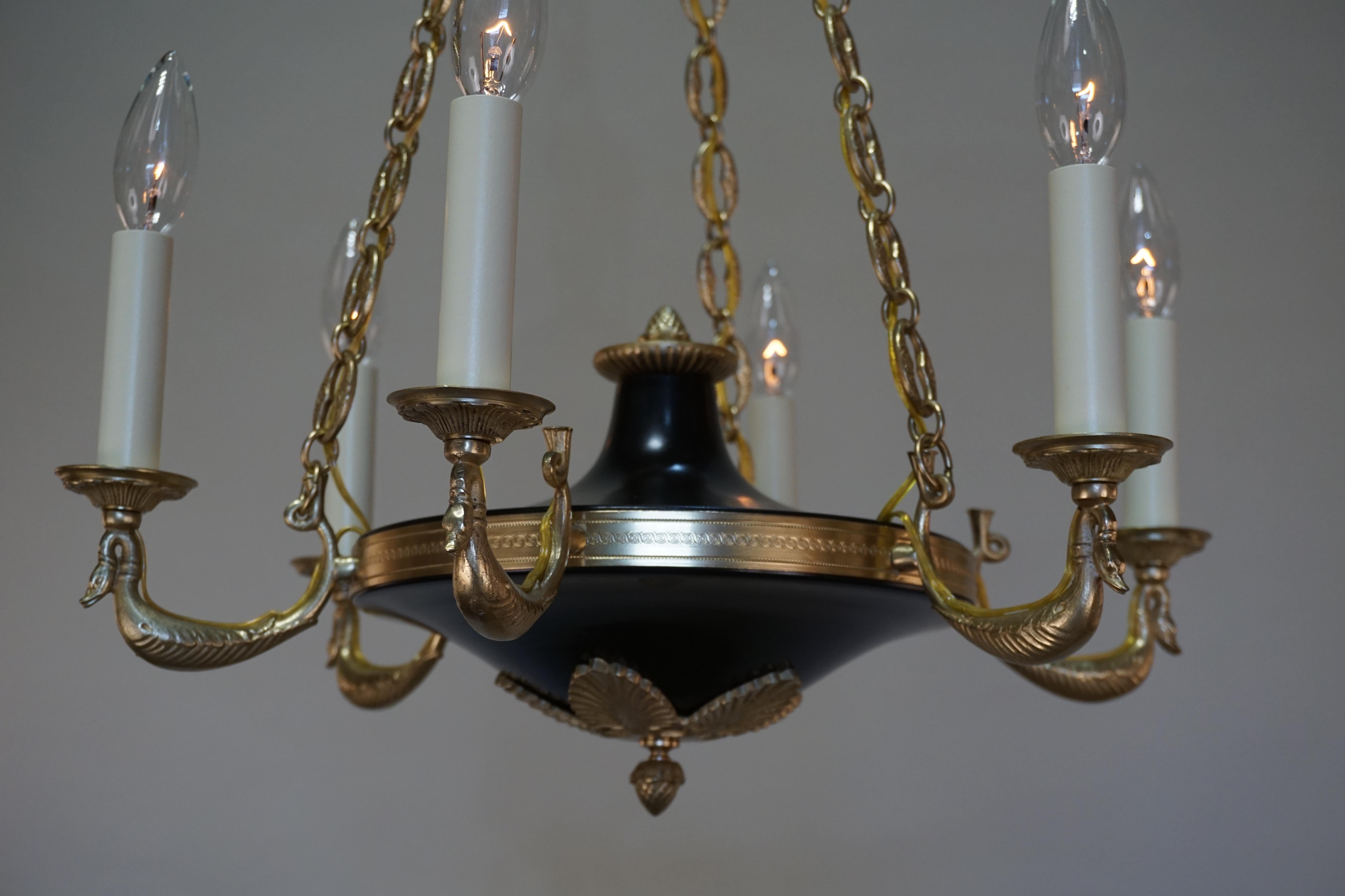 An elegant six-arm French bronze and black lacquer chandelier.