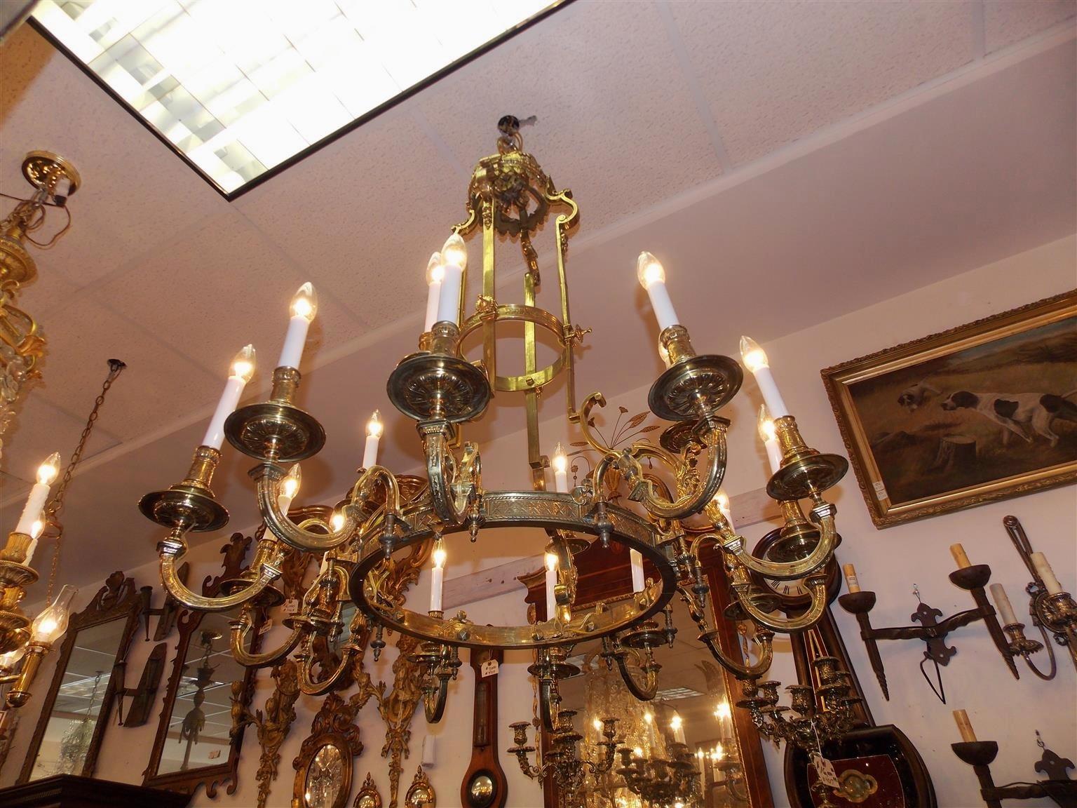 French bronze figural and foliage two-tiered elongated sixteen-light chandelier with four pulley system under dome finial. Chandelier was originally candle powered and has been electrified. Early 19th century.