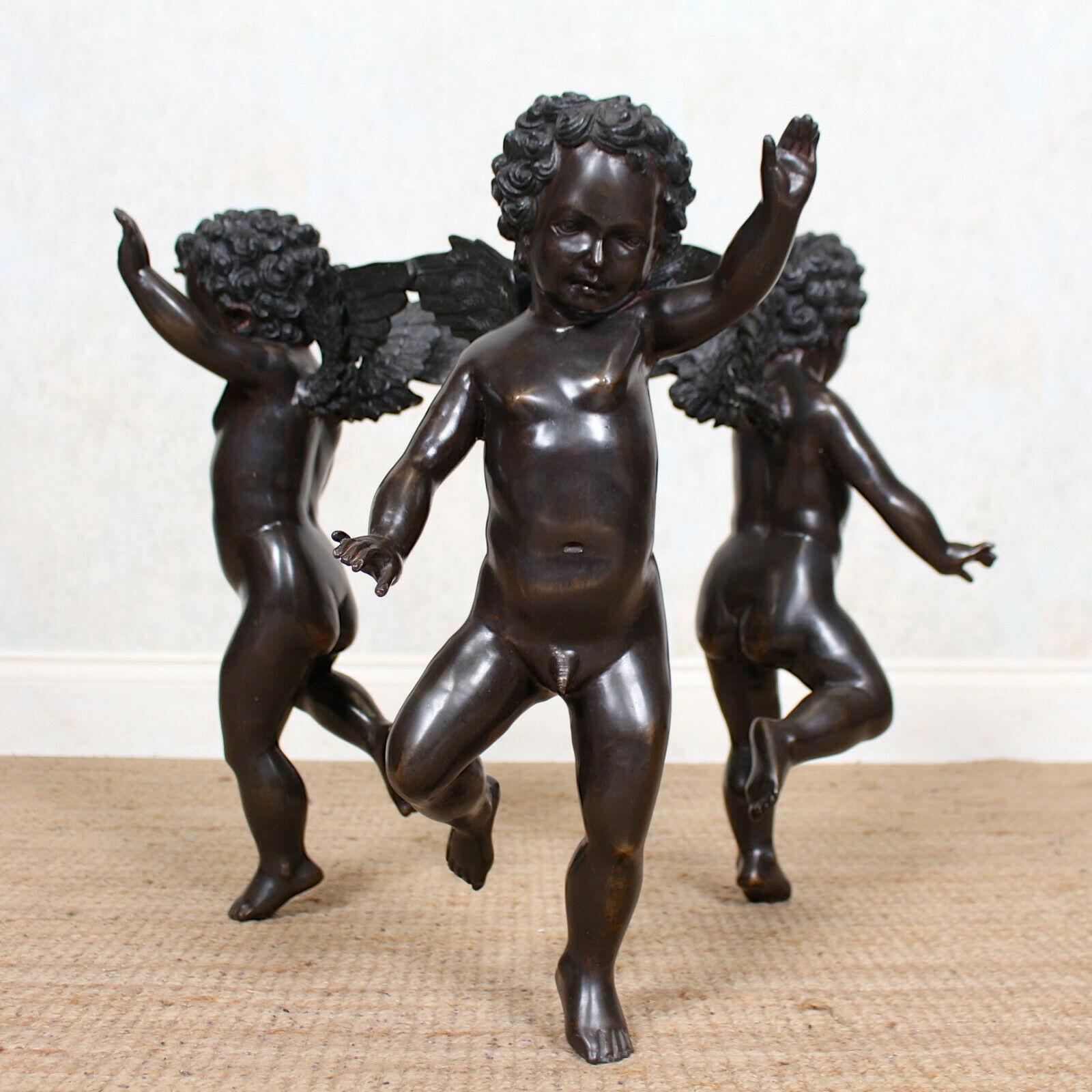 A fine quality French 20th century bronze and glass coffee table.
The circular glass top raised on a base of three bronze winged cherubs,
France, 20th century.
  