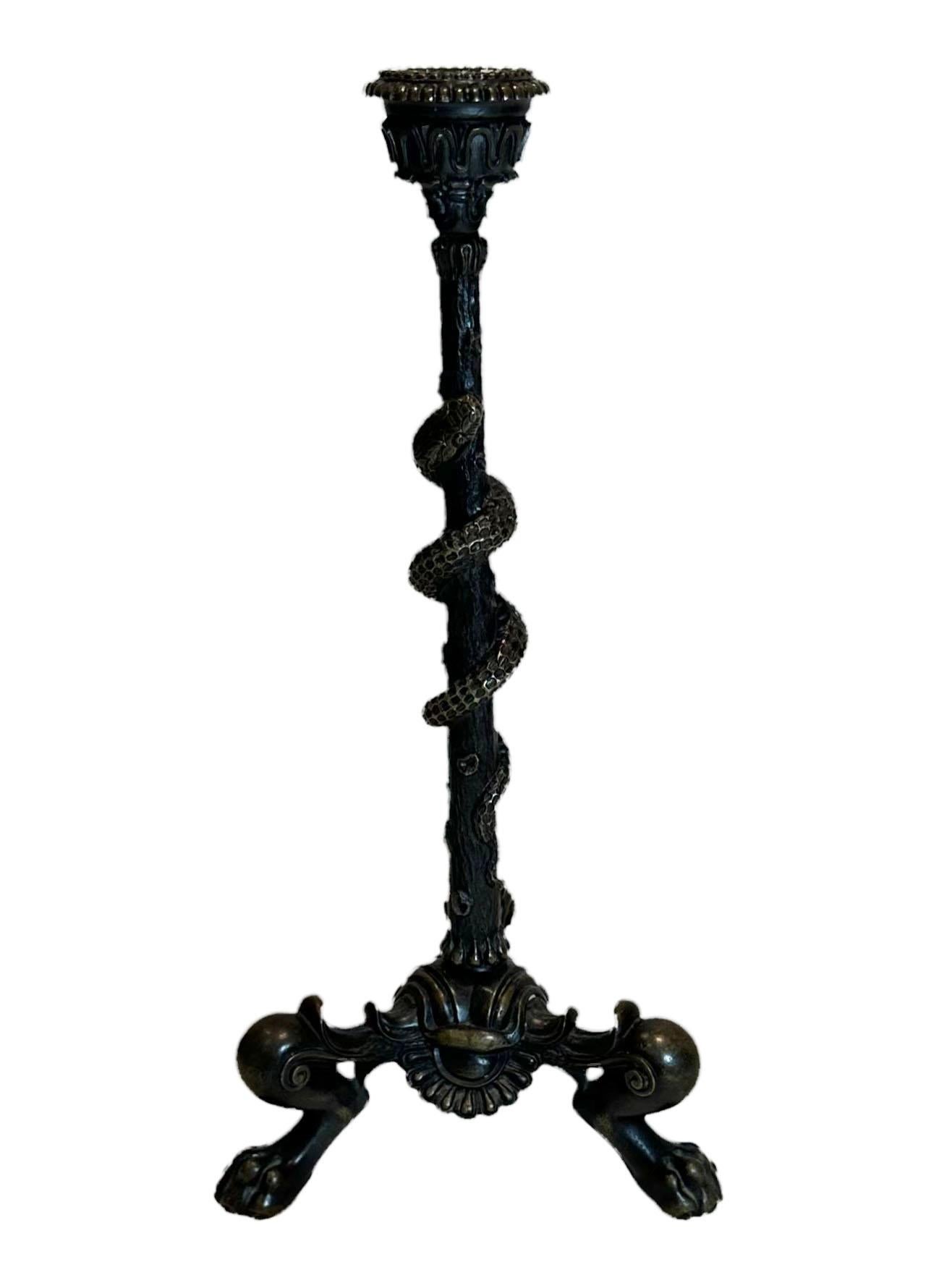 A single 19th century solid bronze grand tour candleholder with a tripod bottom. French and it is very high-quality with a dark patina.
