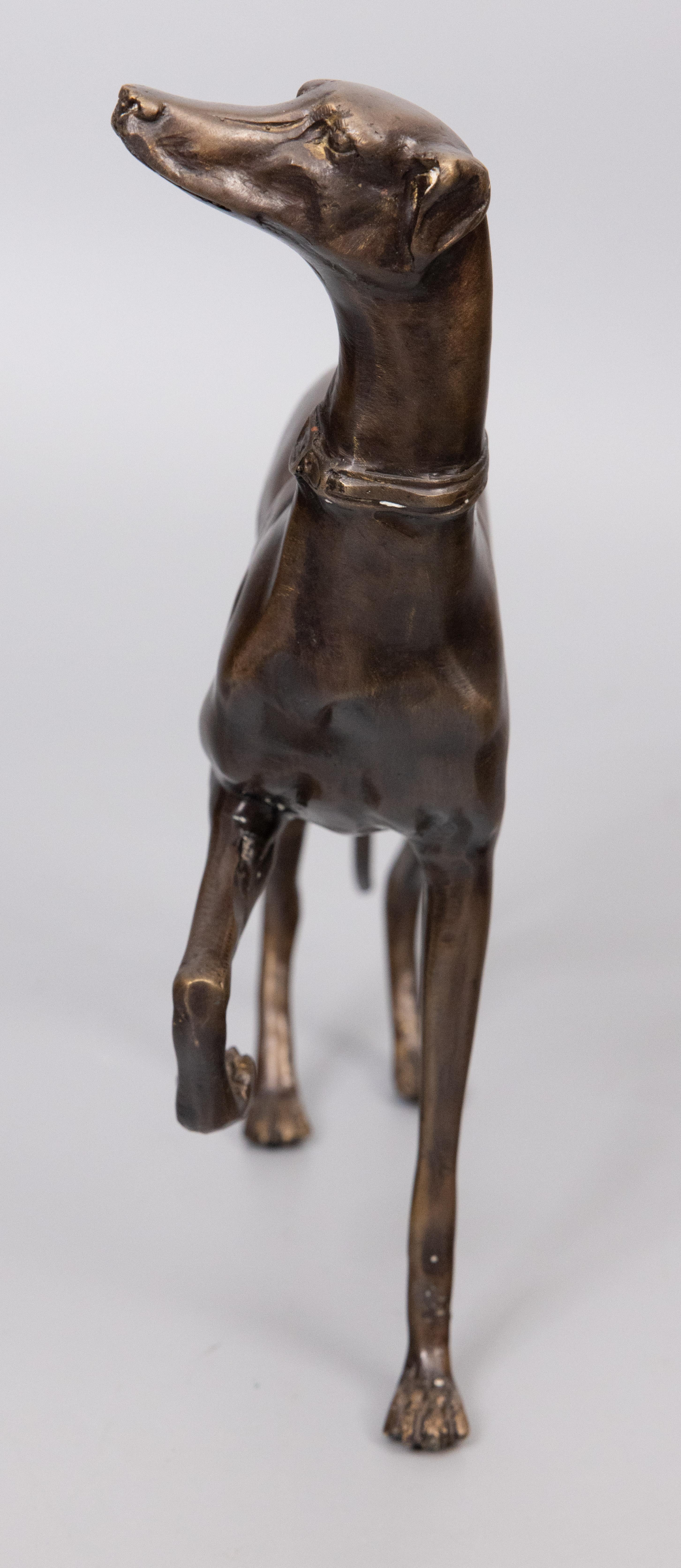 A stately French bronze greyhound whippet dog sculpture figurine, circa 1960. This fine dog has a wonderful expression with great details and a lovely aged bronze patina. It is well made, solid and heavy, and would be a handsome addition to a study