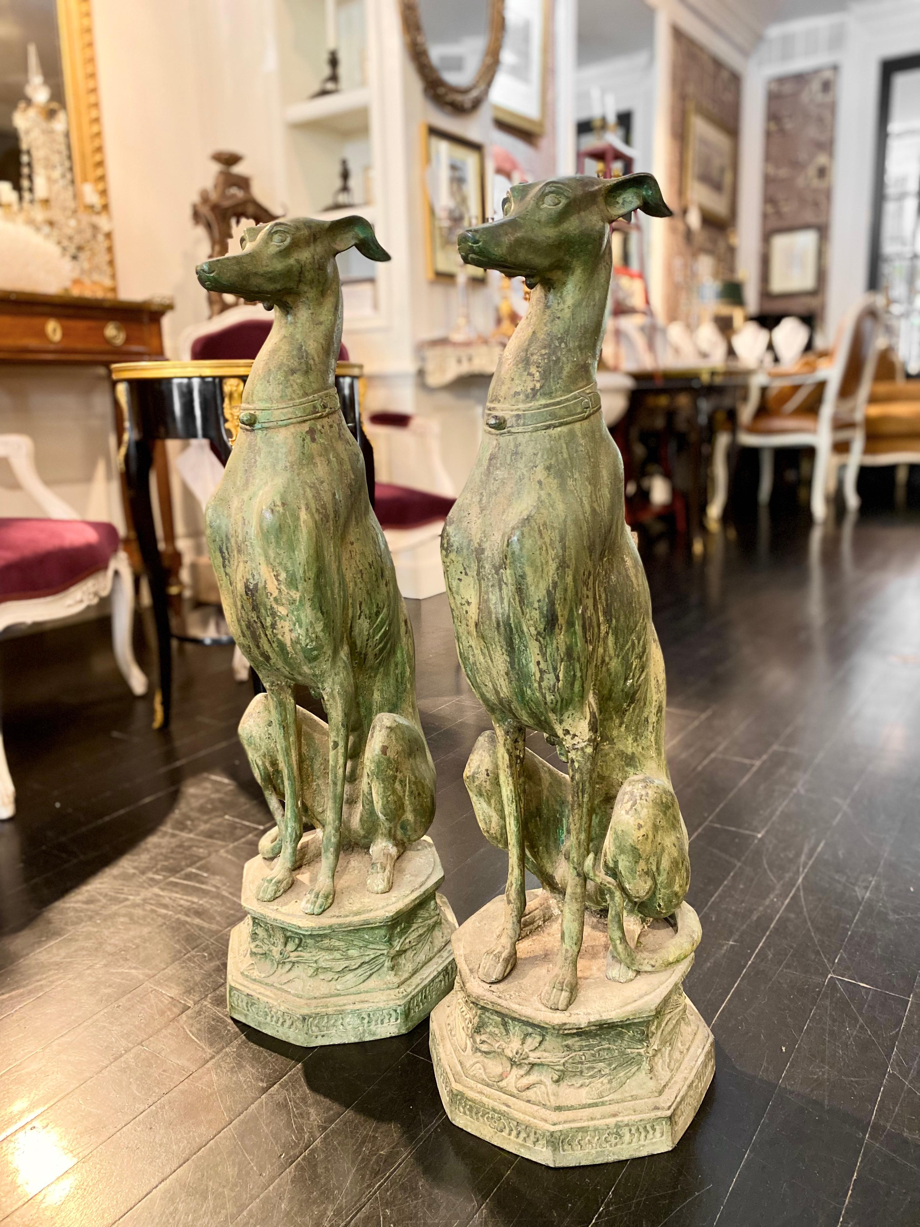 A large pair of French bronze greyhounds, verdigris patina, beautiful models, mounted upon octogonal bronze bases decorated in leaves. Mid-Century Modern chic, they would blend seamlessly in a Hollywood Regency décor.