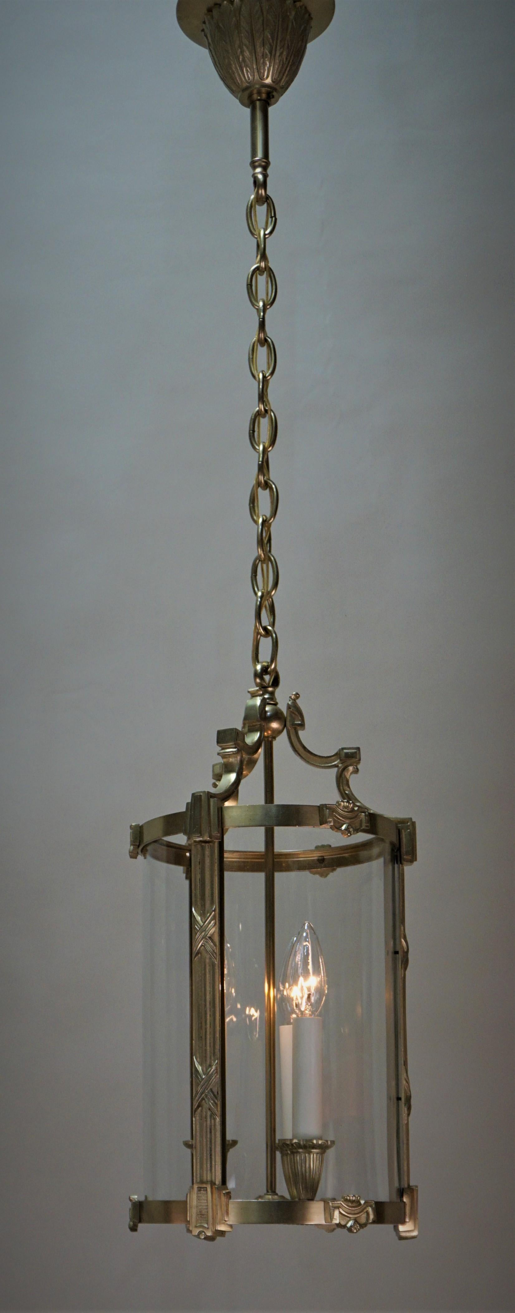 Elegant three-light bronze lantern with three panel bent glass lantern by Atelier Petitot
Minimum height fully installed is 25