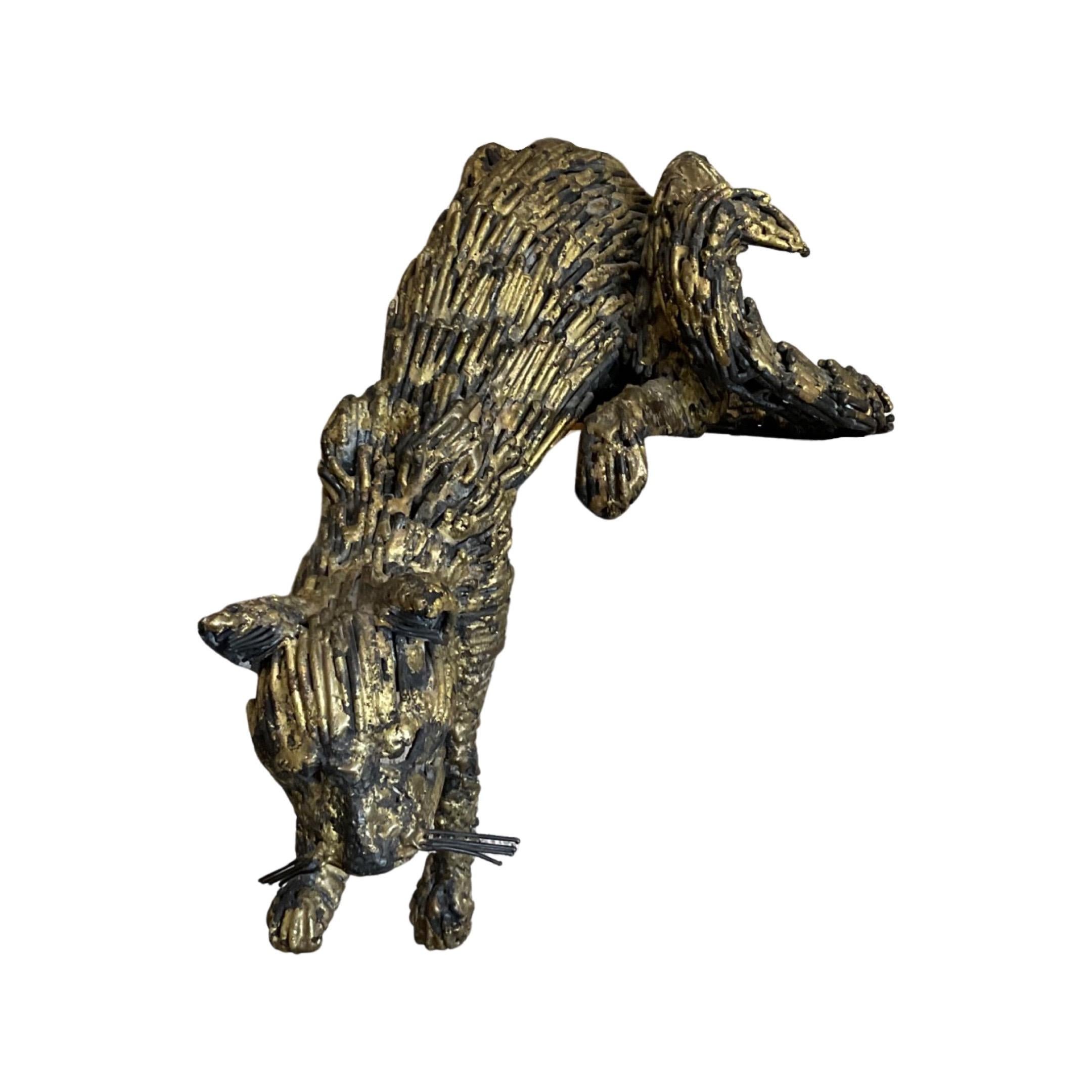 This French-made bronze cat sculpture from 1988 is the perfect way to add a unique, artistic touch to your space. The gold leaf finish and design suited for hanging off a ledge make it an eye-catching piece. Bring the perfect combination of vintage