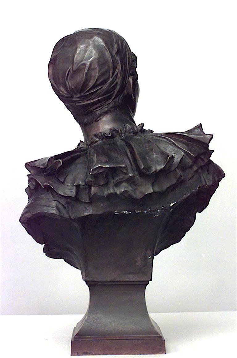French bronze life size bust of harlequin on square shaped base (19/20th Century) (signed, Andre Laoust).
