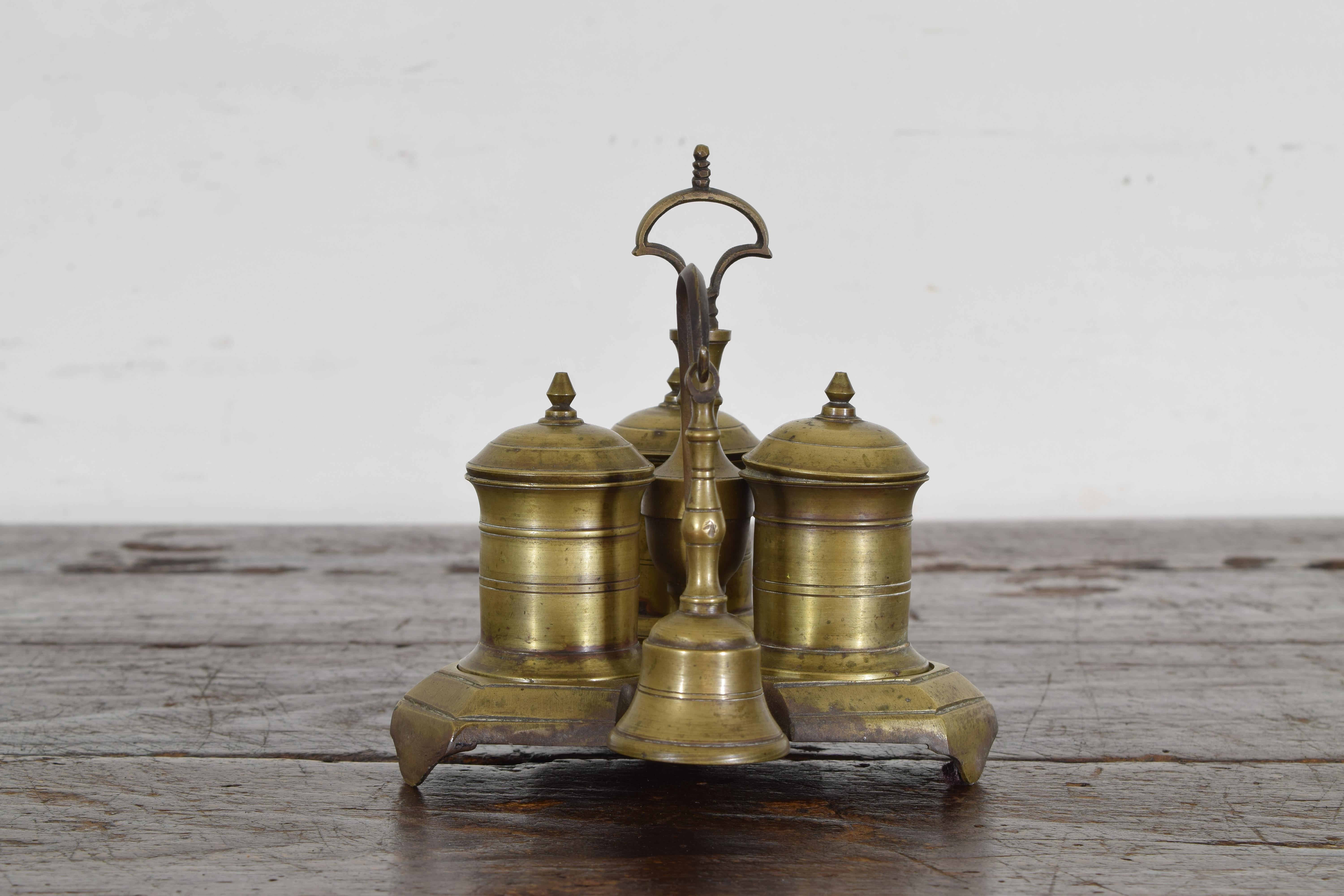 The shaped and footed platform or stand with a central carrying handle and three fitted sections housing two inkwells and a sandwell all with removable lids, extending outward from the stand is a hook with a servant bell.