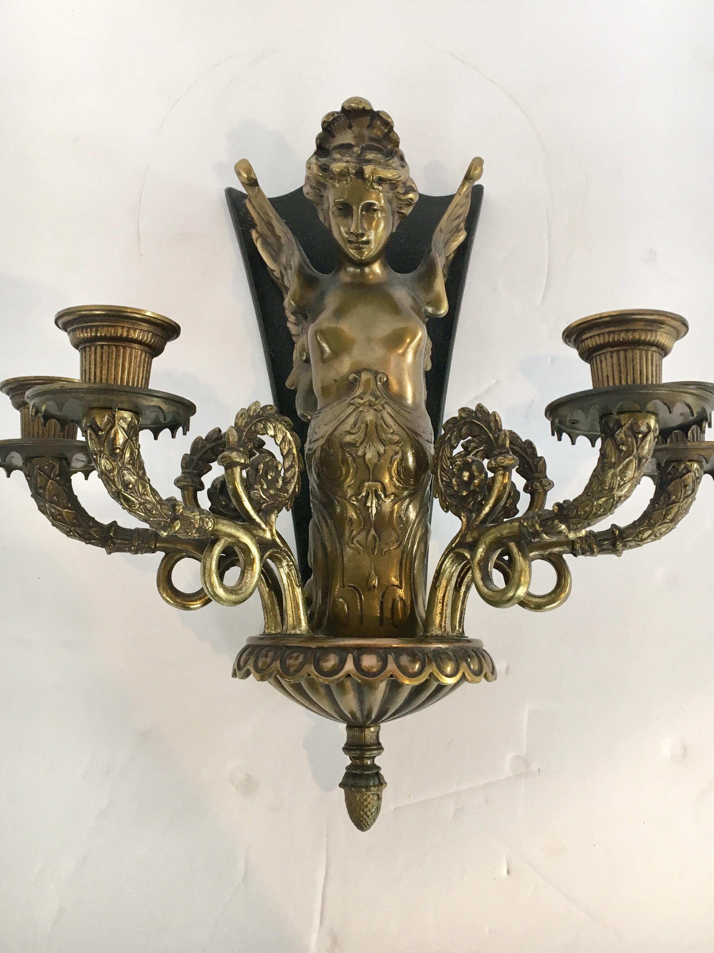Stunning four arm heavy bronze wall sconce with woman with wings as central theme. Nothing short of gorgeous.