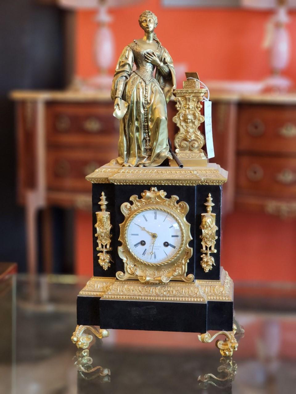 This stunning clock sits at 23.50 in. Perfect for any desk or study décor. Inspired by the early 1800's. Polished regularly.