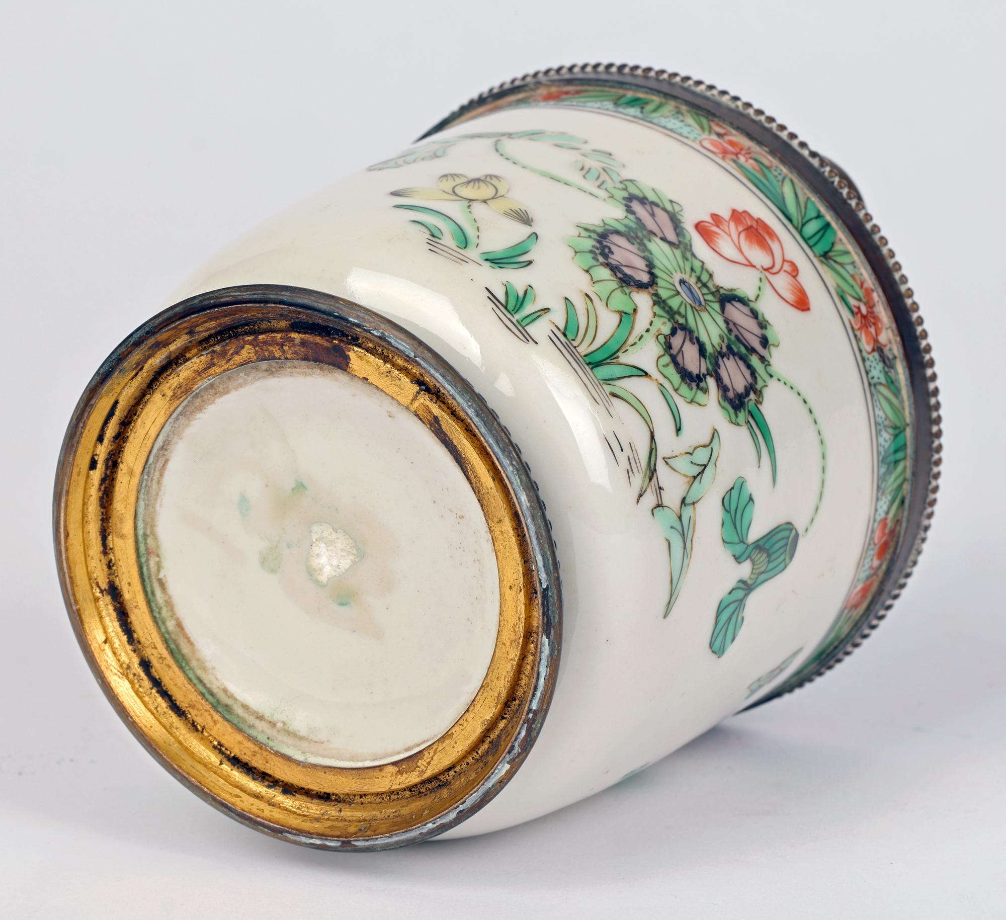 A good quality bronzed mounted French porcelain inkwell with Chinoiserie floral painted designs possibly made by Samson of Paris in the second half of the 19th century. The inkwell is of round almost cylindrical shape and stands on a bronzed foot