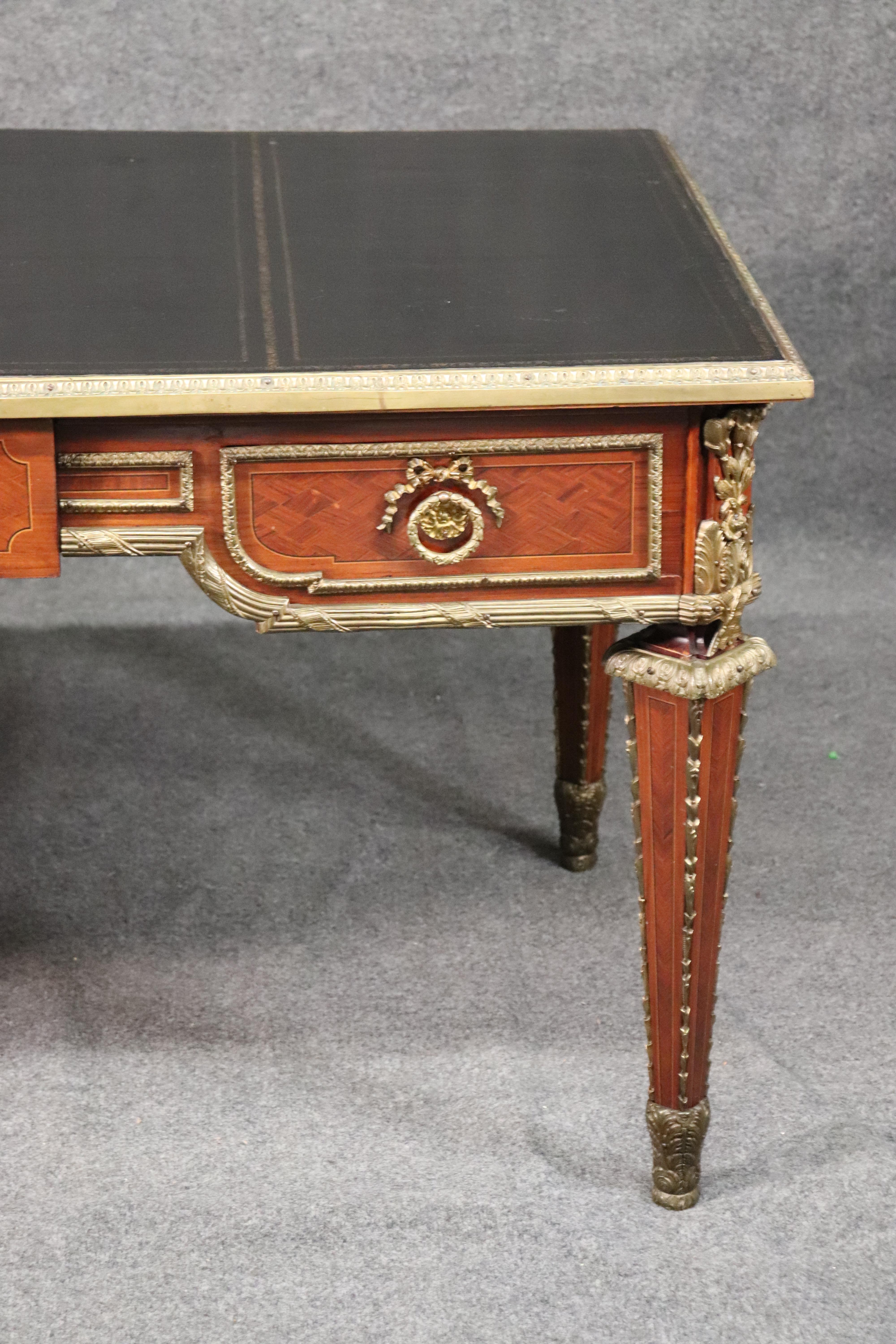 This is a stunning desk with superb quality bronze mounts and a fantastic black leather top, circa 1930. The desk is in gorgeous condition for its age and is a very unique form and design. This is one of the finest of its type we have had in a