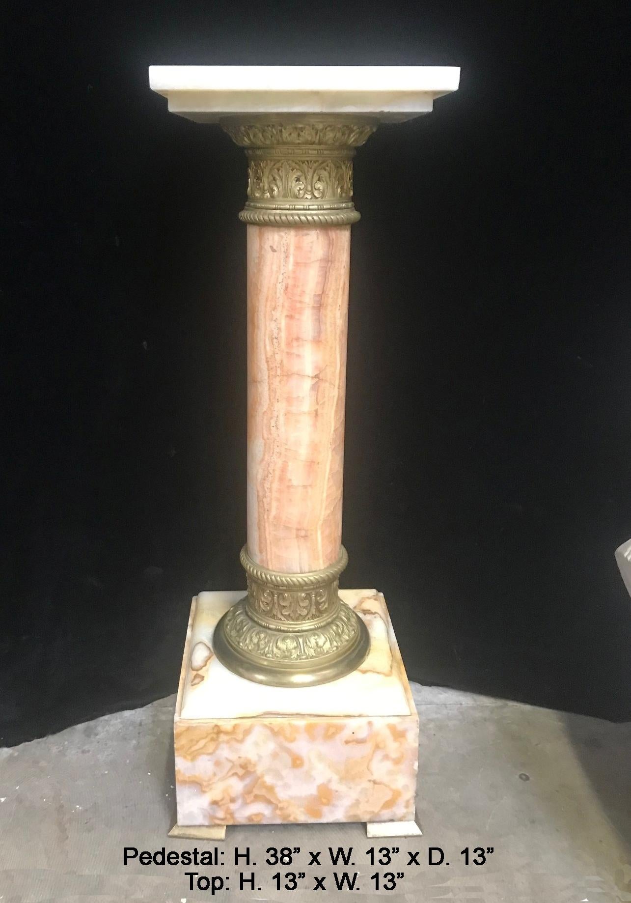 An impressive 19th Century French bronze mounted onyx pedestal.
The pedestal is surmounted by a square onyx top, over an onyx column mounted with foliate-inspired and reeded gilt bronze, raised on an onyx base.
Top size : 12.5