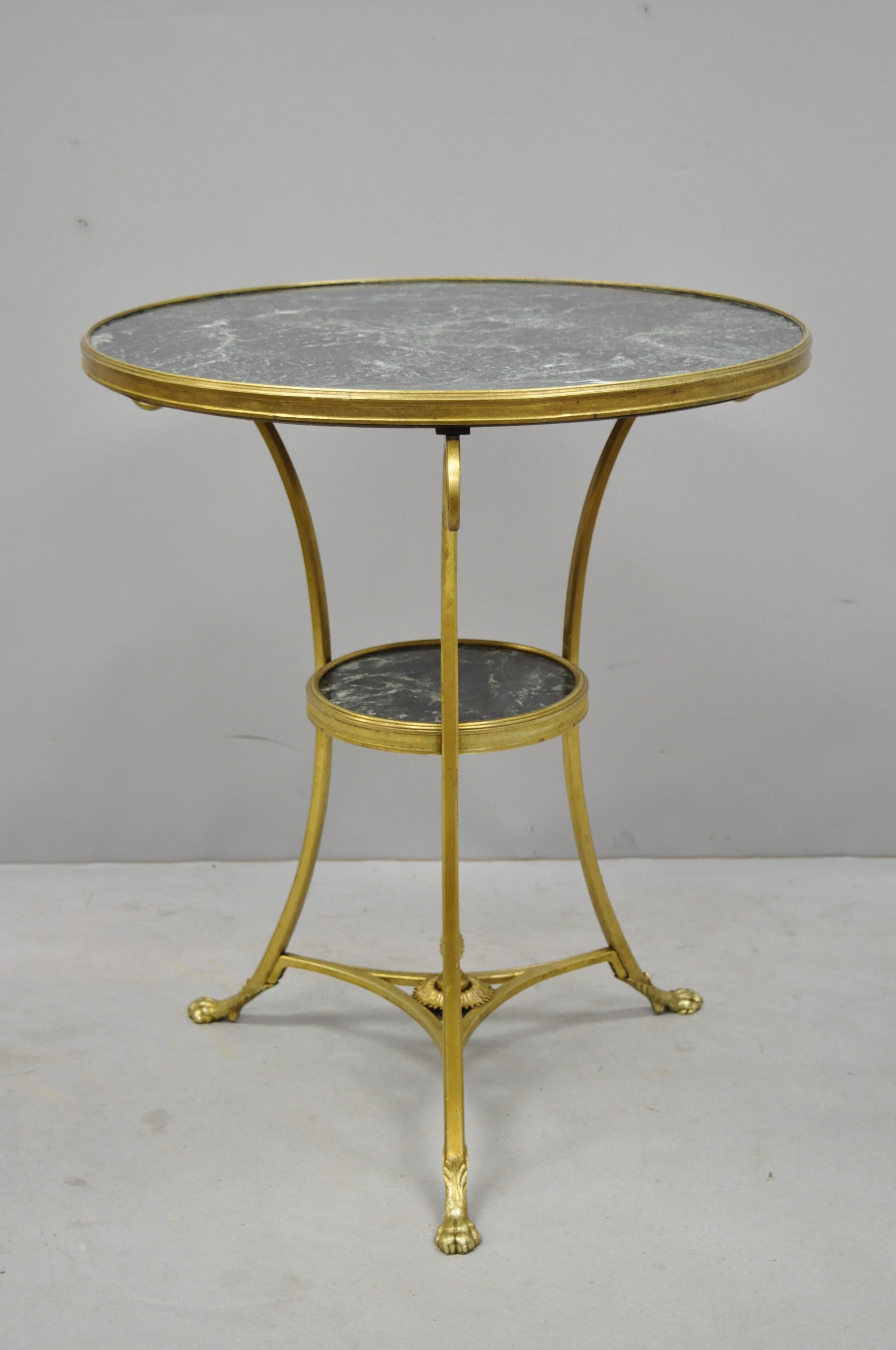 Early 20th century French bronze neoclassical round green marble top gueridon centre lamp table. Item features (2) green marble round tiers, bronze frame, claw feet, very nice antique item, quality craftsmanship, great style and form, circa early