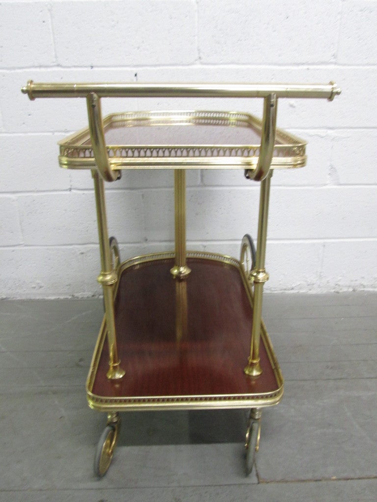 French bronze rolling tea, bar cart. The two tiers have laminated tops. Trolley.