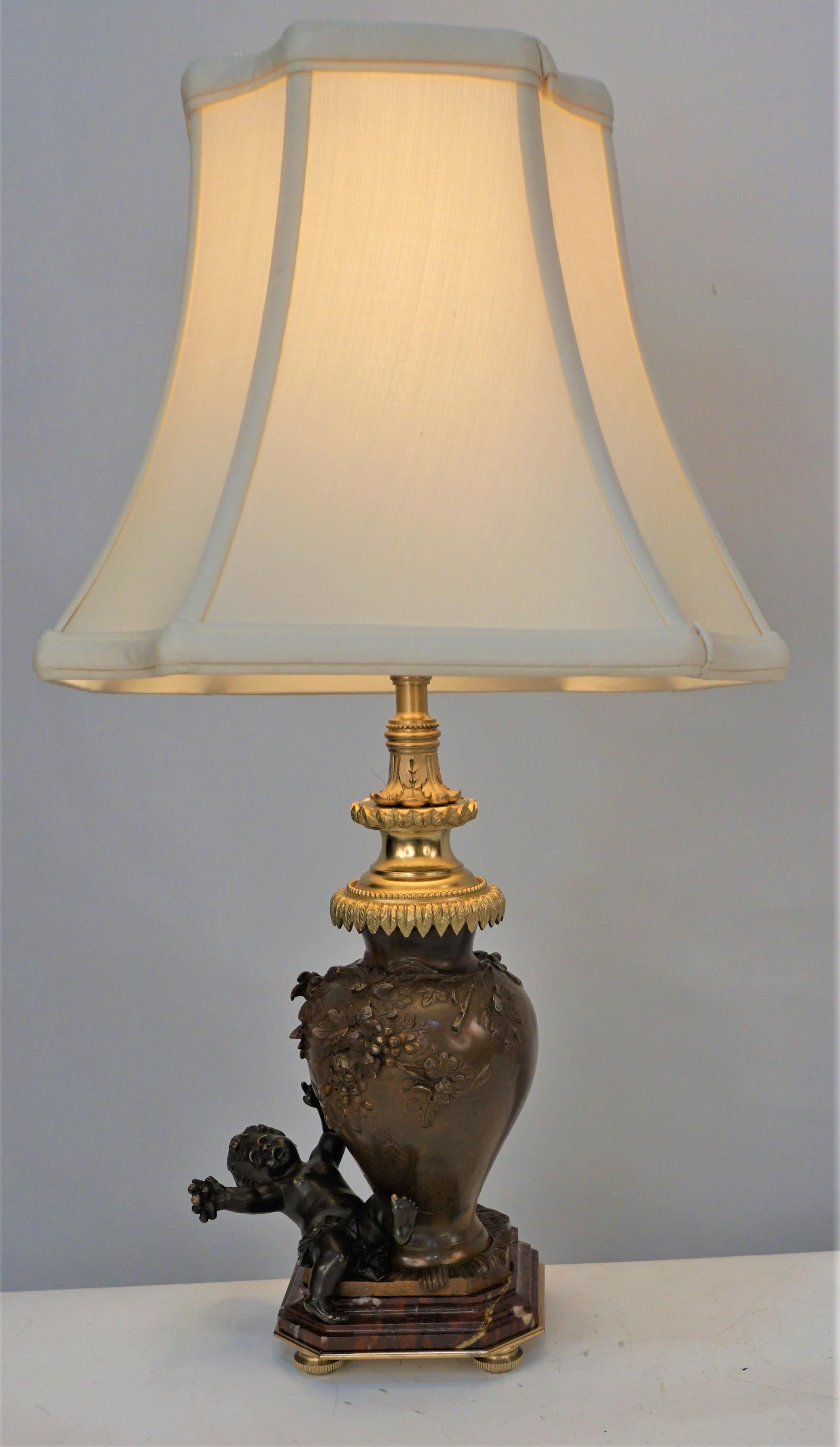 Beautiful bronze oil lamp base by Auguste Moreau that has been electrified and fitted with silk lampshade.
