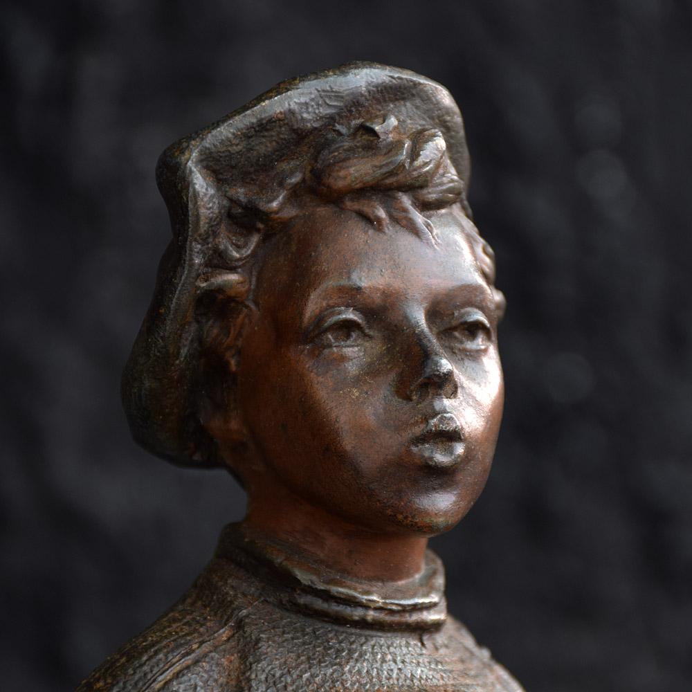 We are proud to offer a wonderful example of a late 19th century bronze spelter statue named Le Petit Sifleur (the little whistling boy) stamped at the base Siffleur. A rare example in this form wearing boots and socks. This statue is highly
