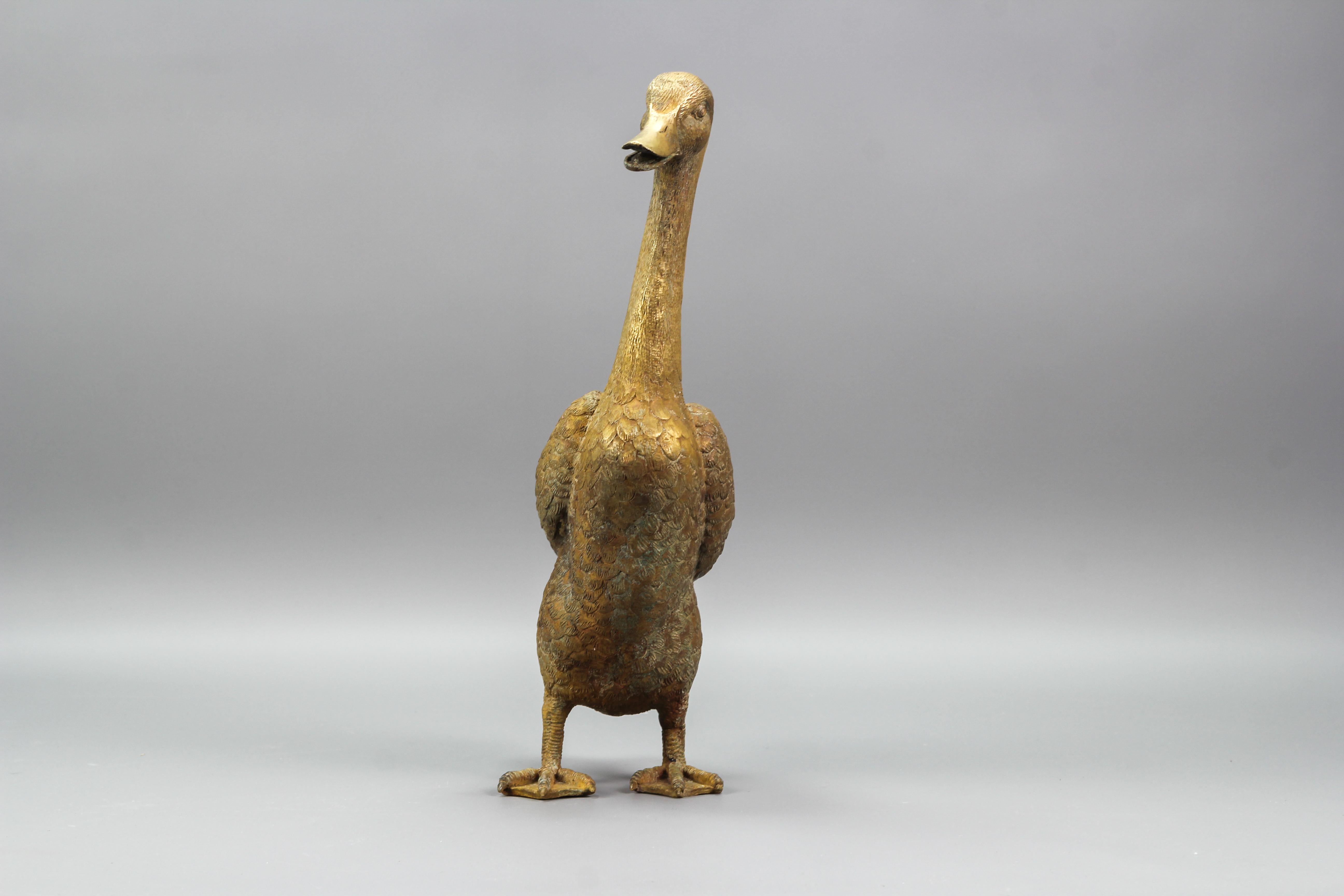 Absolutely charming bronze duck statue. Made in the 1950s - 1960s in France, this beautiful duck figure features excellent, realistic details and superb patina on bronze. As a very decorative object, this vintage duck is a real eye-catcher in any