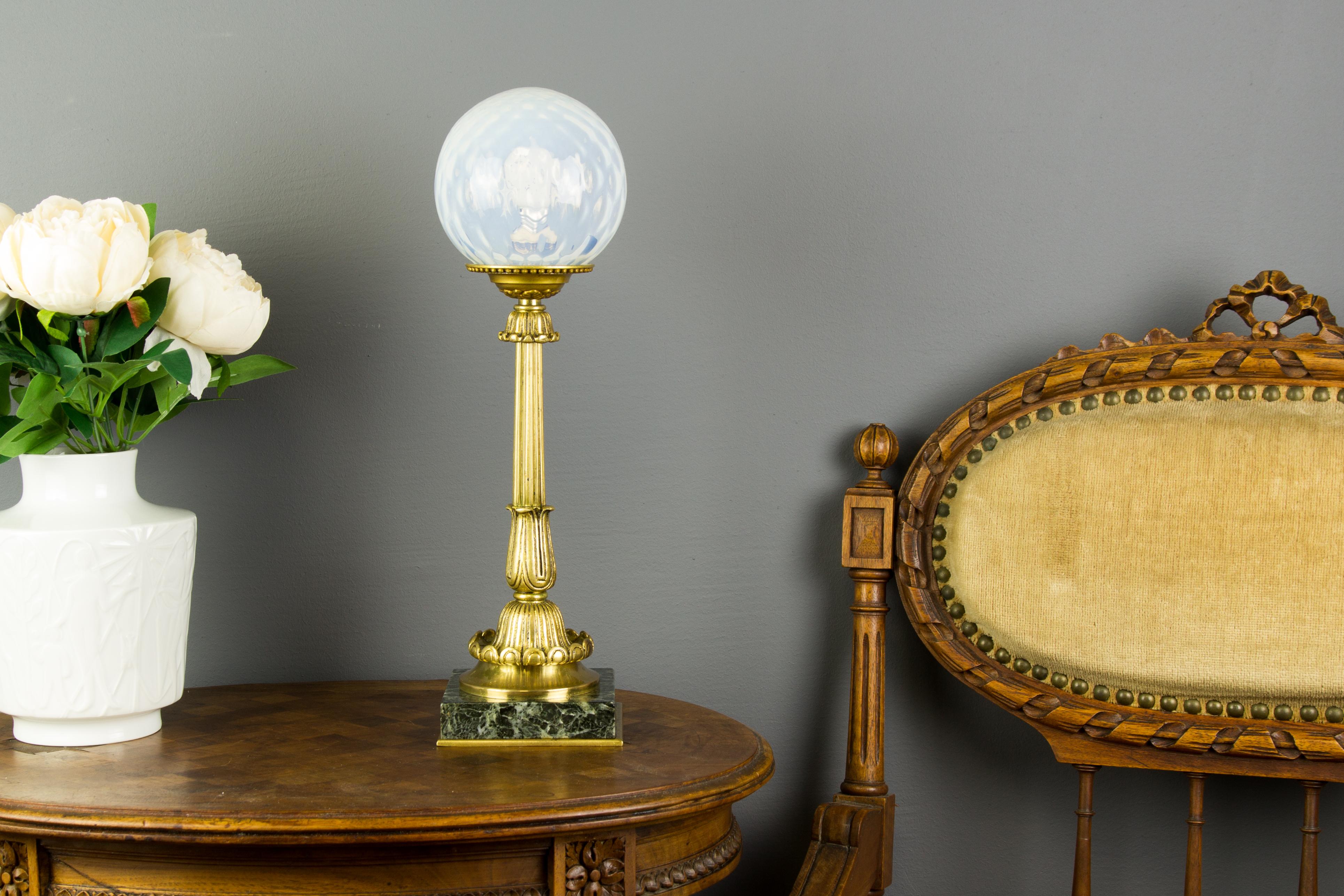 Elegant French Louis XVI style bronze table lamp on marble square base with beautiful opalescent glass shade. One socket for the E14 size light bulb.
Dimensions: height 37 cm / 14.56 in, width 10 cm / 3.93 in, depth 10 cm / 3.93 in.
 