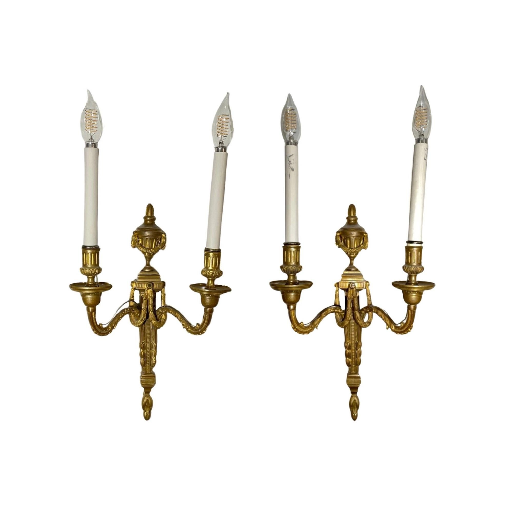This is a pair of French wall sconces from the mid-18th century made from bronze. They feature intricate design details and are suitable for illuminating a range of settings in your home or office. Add a timeless, classic touch to your room with
