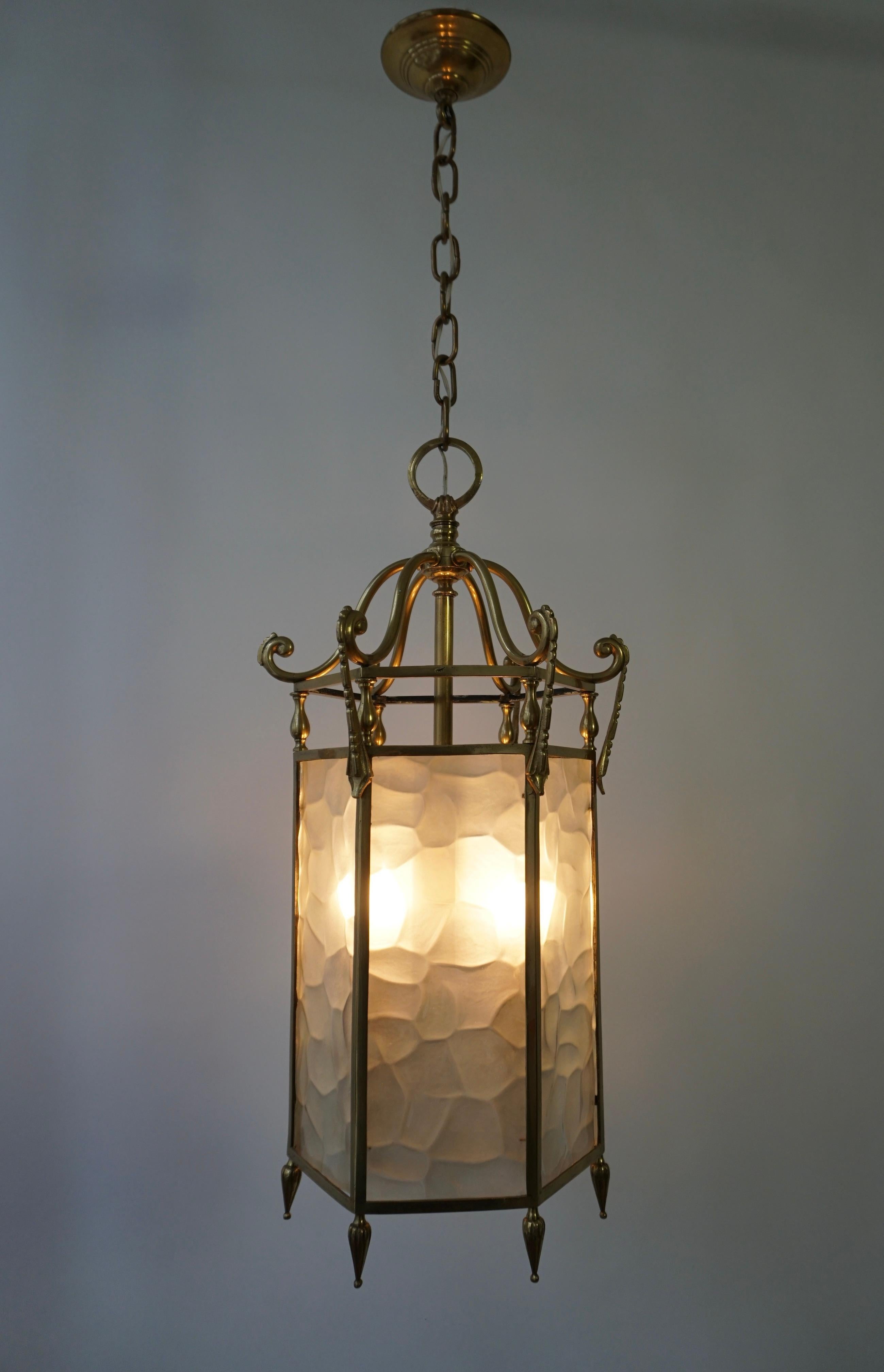 20th century pendant lantern with bronze finish with six white textured glass side panels, chain and canopy. 
Takes 3 candelabra style light bulbs. 

The lantern has three sockets for small incandescent lamps with screw base or E14 type LEDs. It is