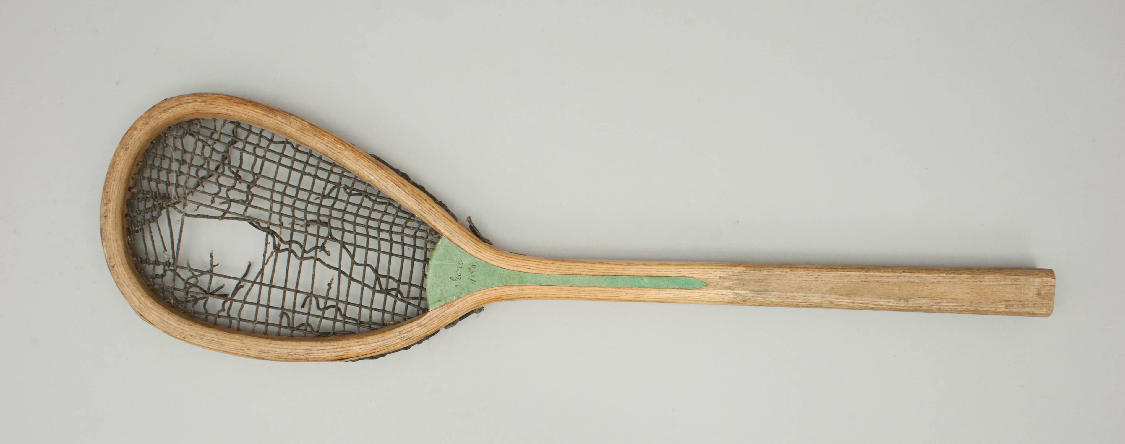 Real Tennis racket.
A rare real tennis racket, manufactured by Brouaye, France, with the original black, course gut stringing. The head of this ash racquet is stamped 'BROUAYE', the convex wedge is covered in green material with one side dated