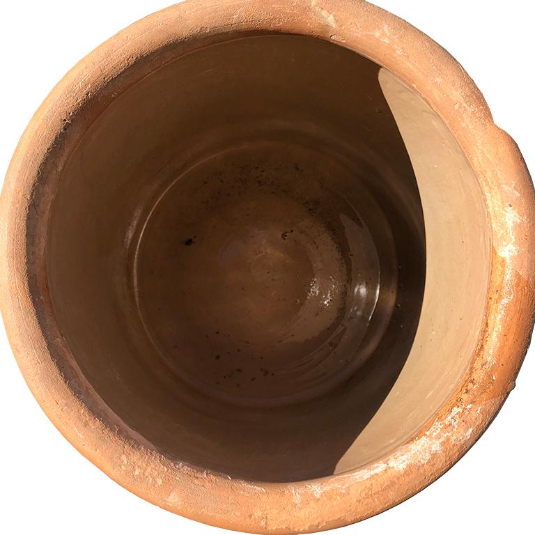 Brown ceramic clay cream crock or planter for the garden. Numbered with the numeral 8. Very heavy. Top features a small lip. These are great for storing items such as umbrellas or blankets in a living room. We like to use ours as planters on the
