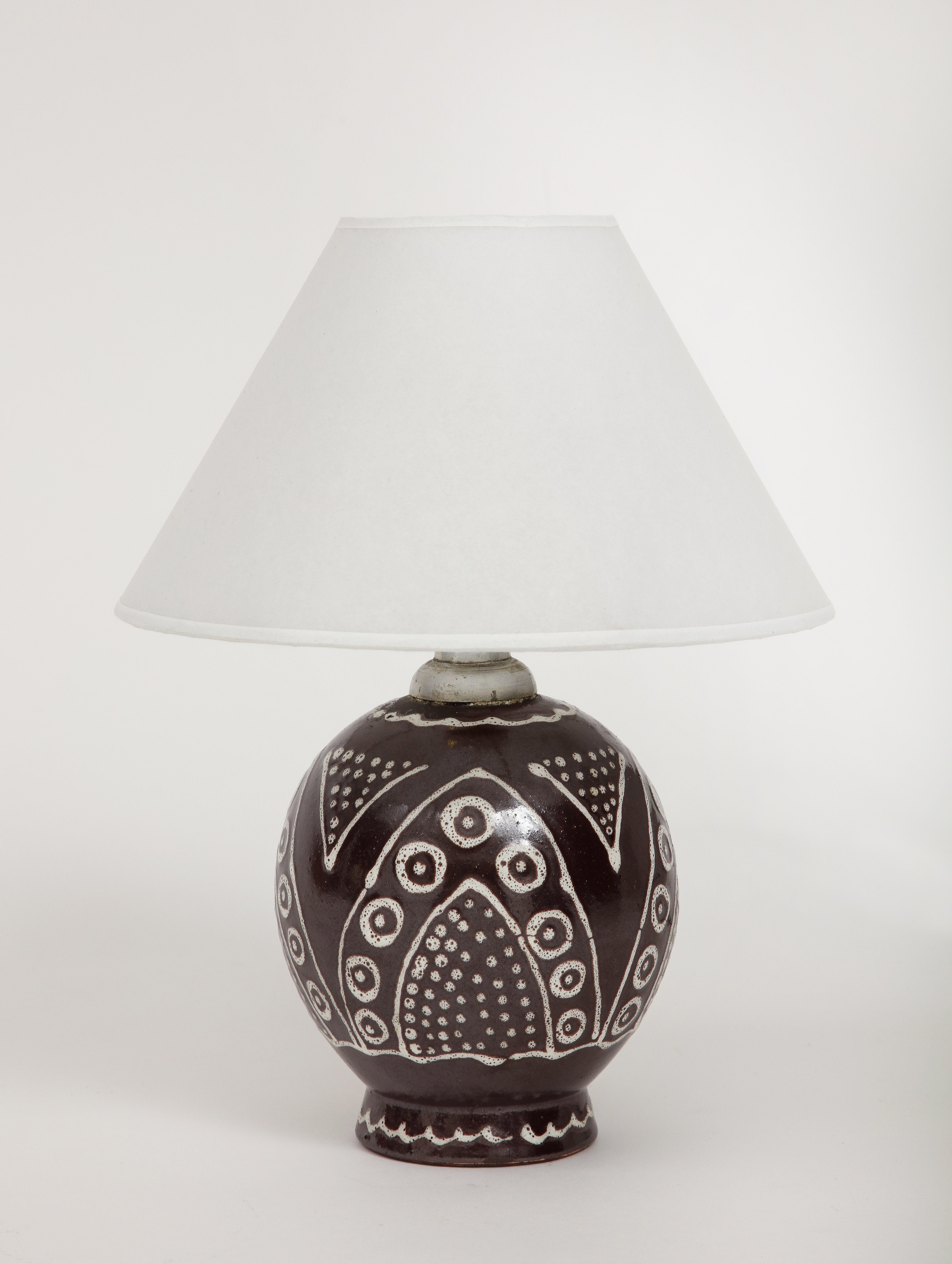 French Ceramic lamp with original hardware, scribe design, c. 1930, Numbered & inscribed in graphite
White Brown Glazed Ceramic

Custom Made Parchment Shade, Rewired, Silk Twist Cord with switch

Measures: Height: 10.75 Diameter. 5 in. Vessel