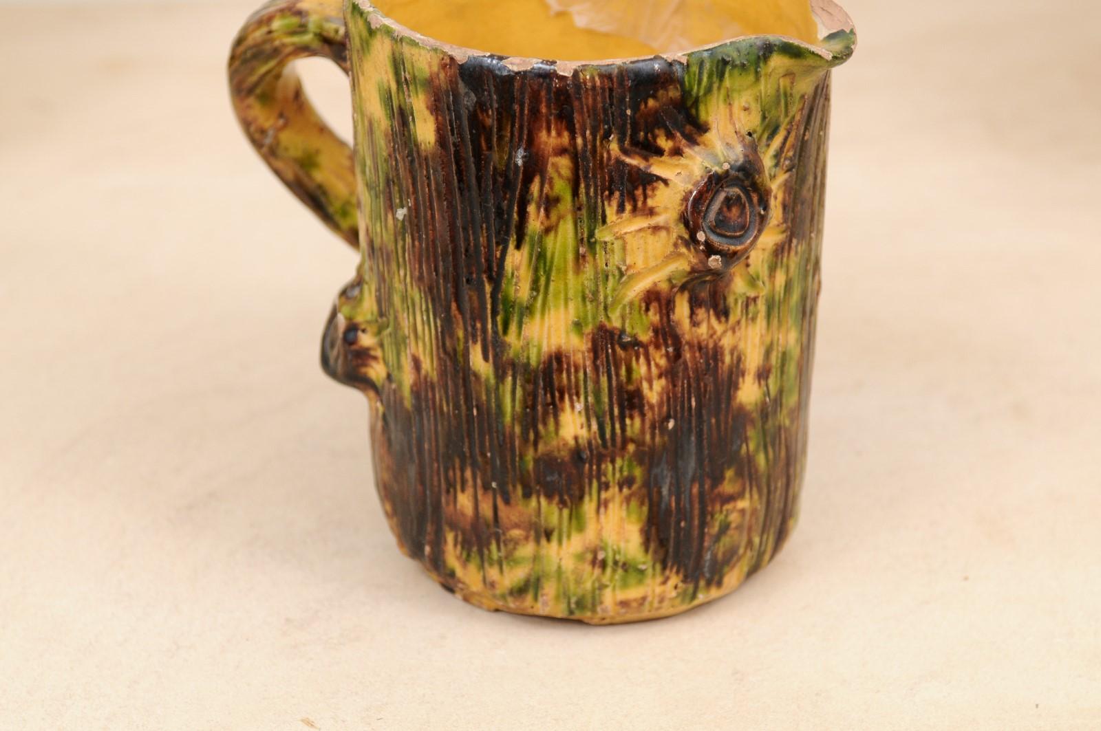 19th Century French Brown Glazed Pottery Pitcher with Yellow and Green Textured Accents