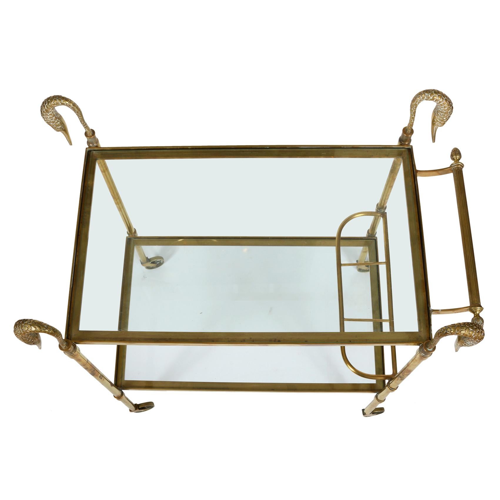 We love bar carts and this one is particularly noteworthy. The brass frame, on casters, supports two glass shelves with a bar for towels and a support for bottles on the lower shelf. The 