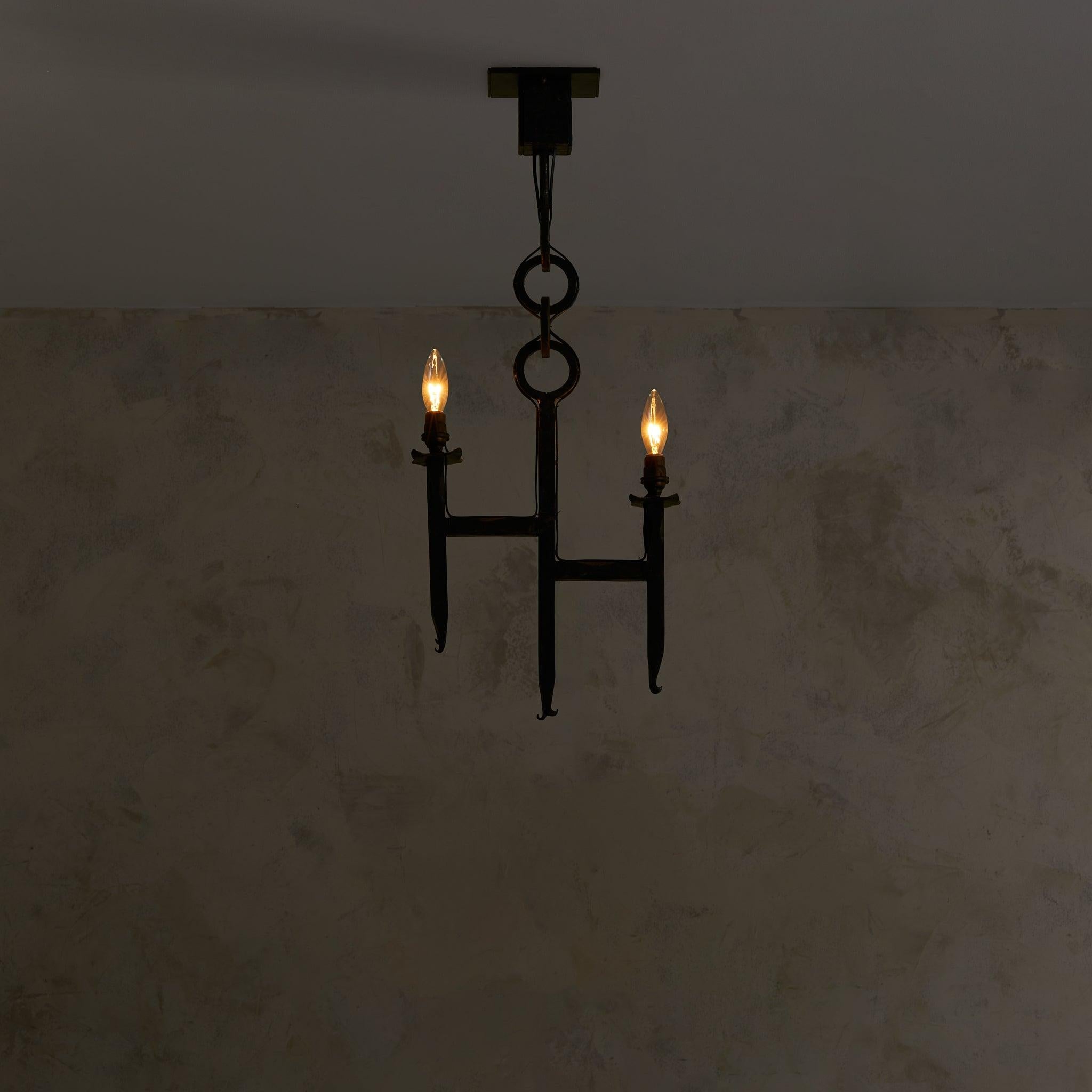 An embodiment of brutalist design, this French iron pendant dates back to the 1960s. Crafted from solid iron with a weathered patina, it showcases rugged craftsmanship, perfect for adding architectural interest to a dining area, entryway, or living