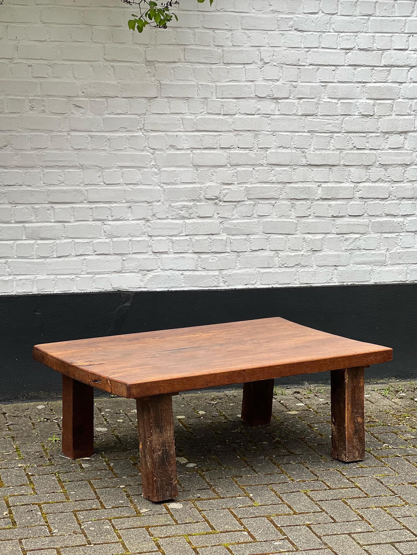 Very unique oak handmade massive slays of tree. The top is patinated and shows various shades of brown/brownish colors and honey tones. Elegant and brutalist describe that table properly. The height is 31.5 cm and is 86 cm x 66 cm. Very strong