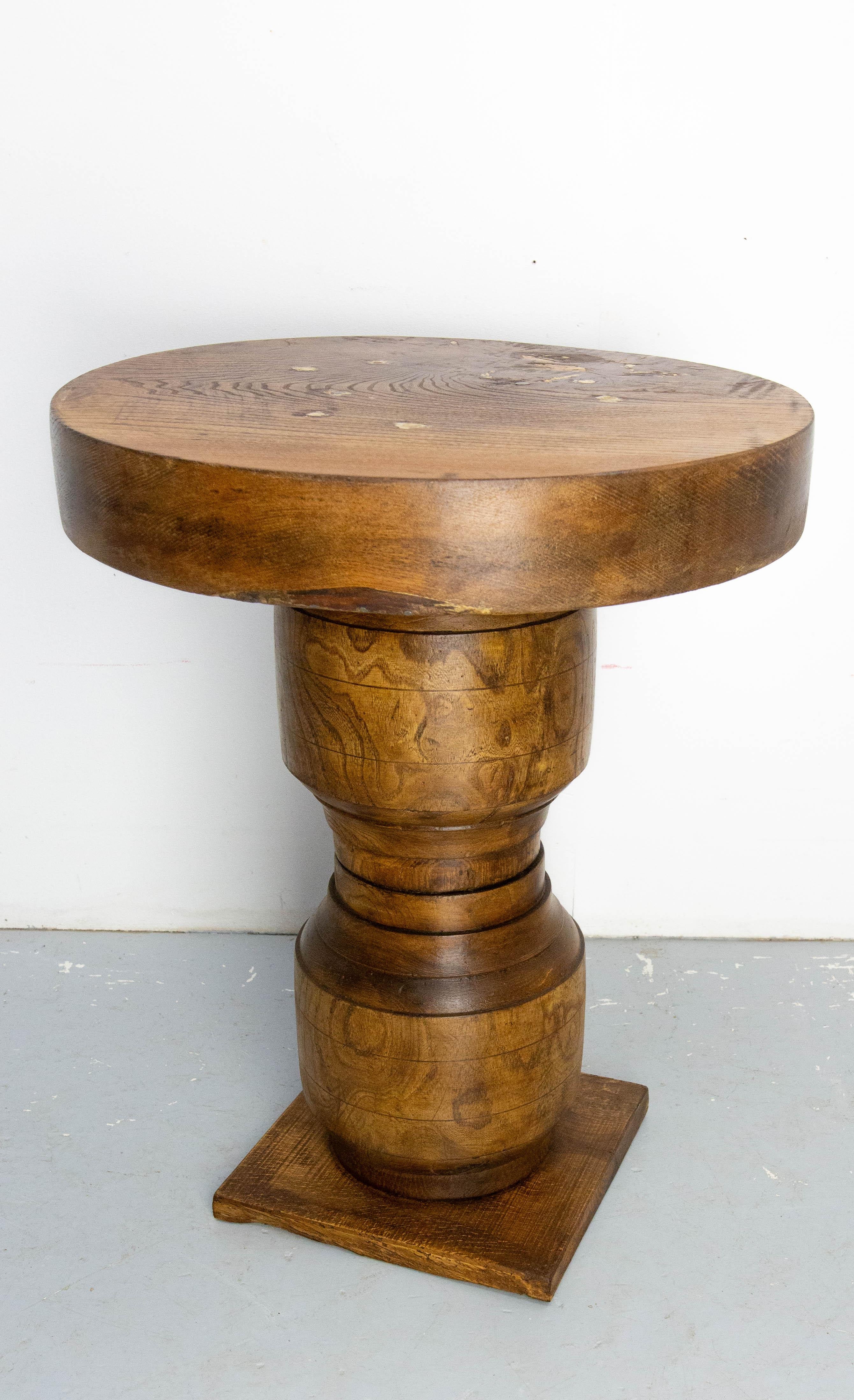 French midcentury coffee table made with two hubs fixed to each other.
The top is also made in massive ash.
The finish marks on the tabletop are original. They are deliberately contrasting, in keeping with the brutalist style of the table.
In good