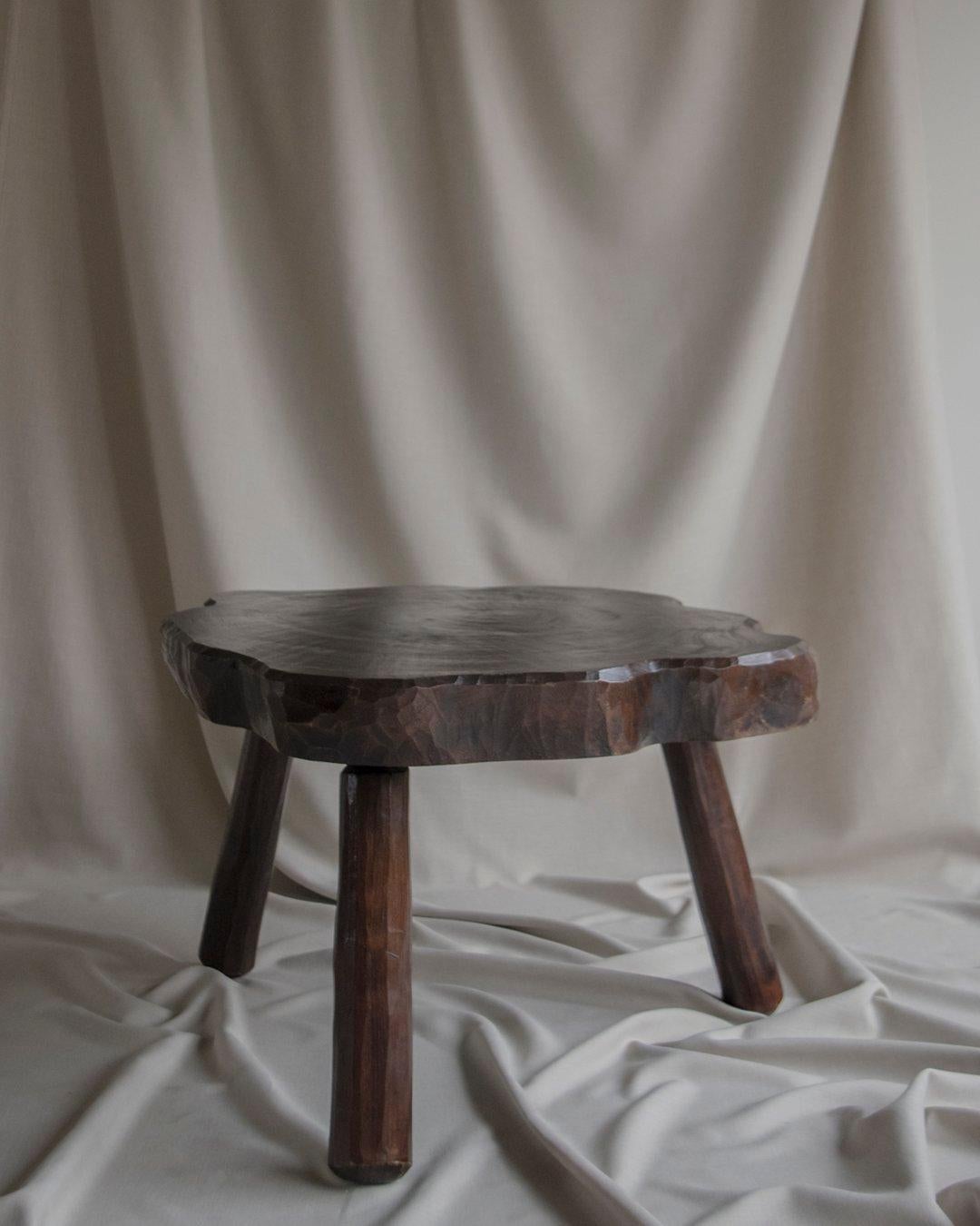 Solid wood - Brutalist center or side table - Circa 1950 France. Fully handmade with amazing carved details. The top is made out of one solid tree trunk. 
Lovely patina and color.

Overall dimensions:
Depth: +/- 77 cm
Width: +/- 75 cm
Height:
