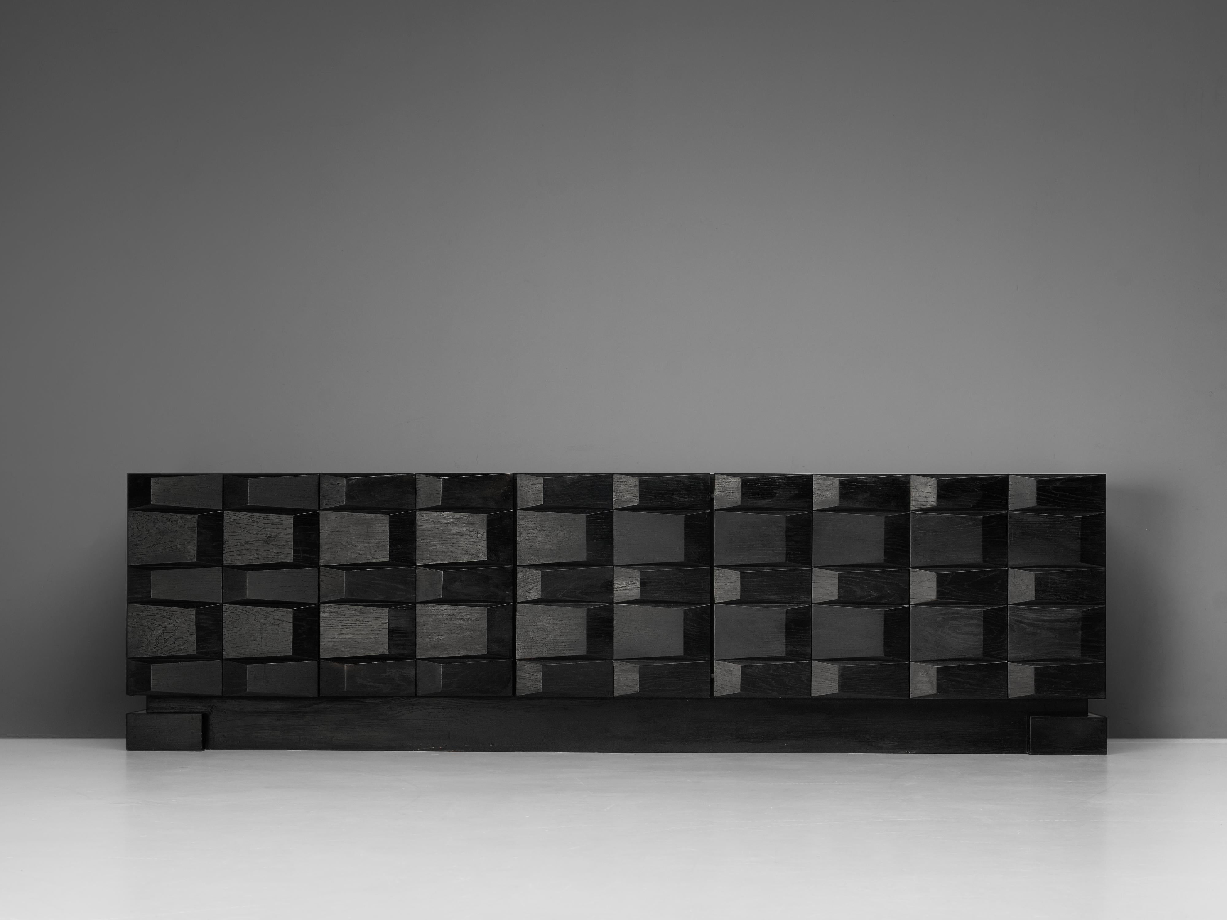 Brutalist sideboard, wood, Belgium, 1980s

Expressive sideboard in black colored wood. This brutalist piece catches the eye. The geometric relief of the front side creates a graphical, geometric look. The three-dimensional feeling creates a strong