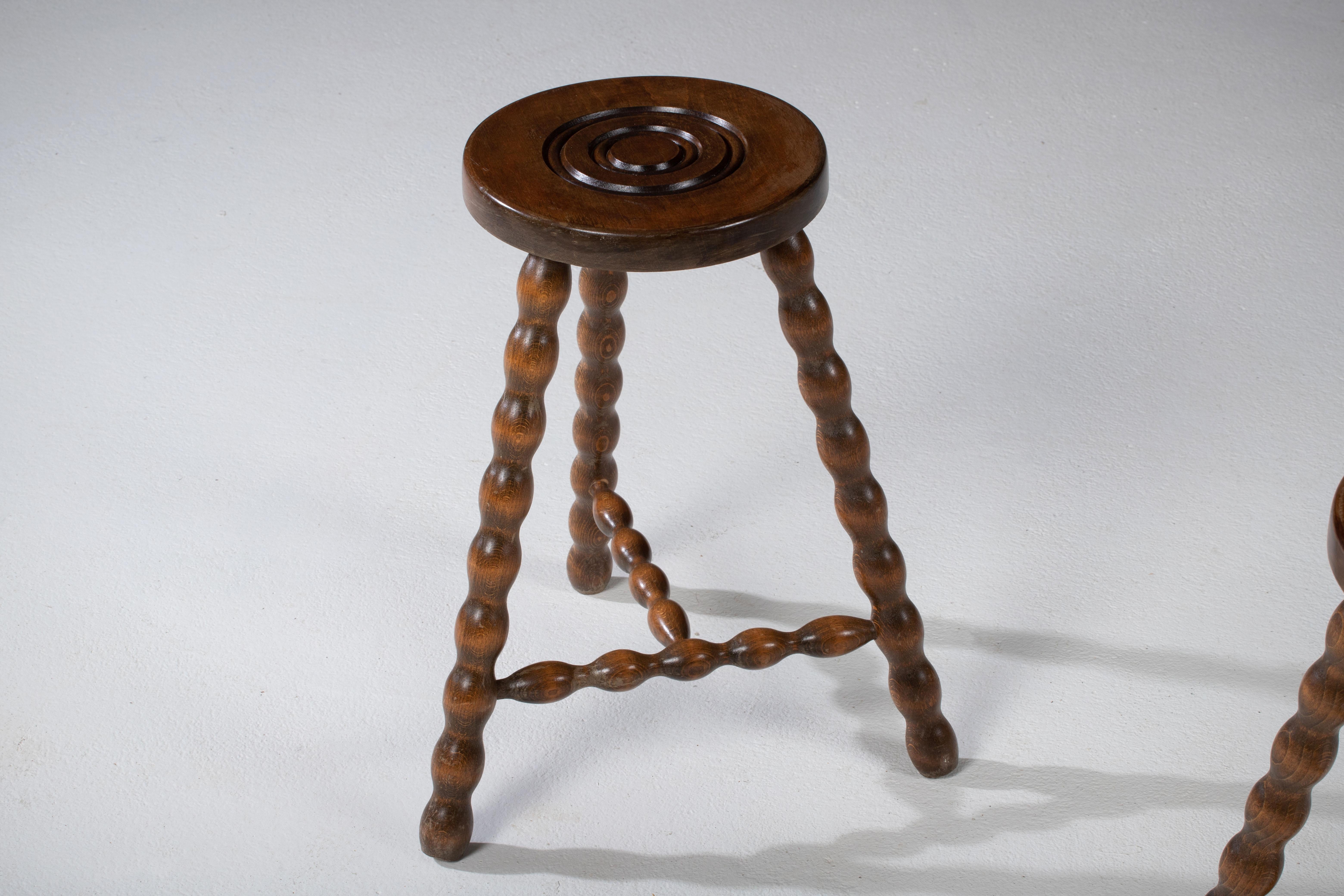 Fantastic wood stool from France in the style of Jean Touret. Made in the 1960s with three legs. No hardware. Good vintage condition.
  