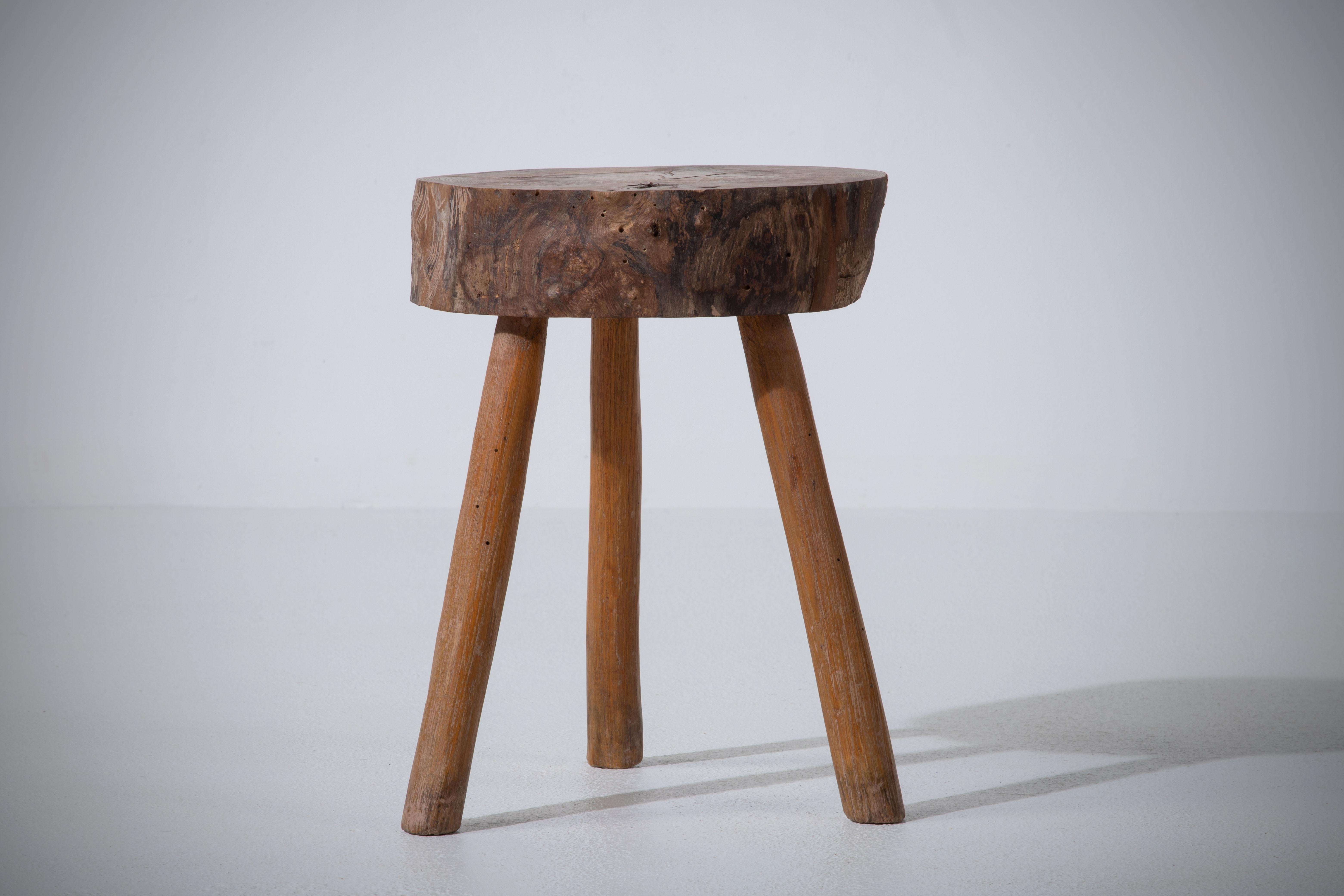 Fantastic wood stool from France in a rustic style. Made in the 1960s with three legs. No hardware. Good vintage condition.
