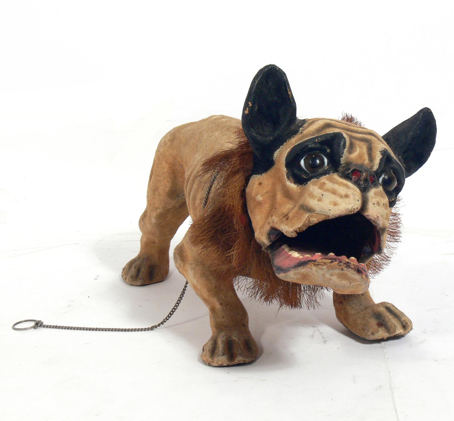 French bulldog growler pull toy, France, circa 1890s. An exceptional example with very expressive face and glass eyes. Pull his chain and his mouth opens and snaps shut and he growls.