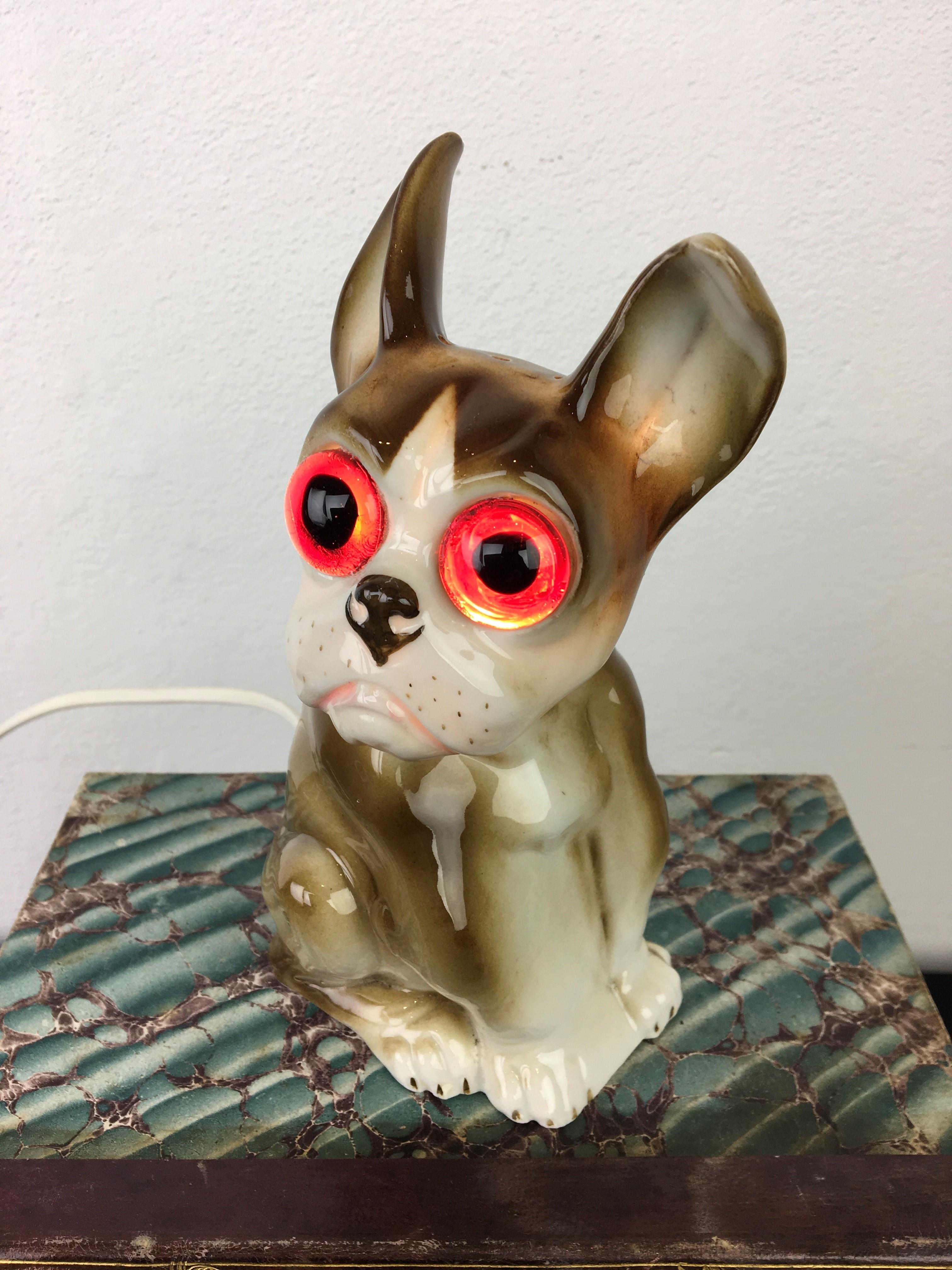 French Bulldog perfume light with large glass eyes.
An Art Deco porcelain scuplture of a bulldog dog in the colors brown and white.
This German air cleaner - perfume light is numbered 6619. 

It's an antique bulldog sculpture still in very